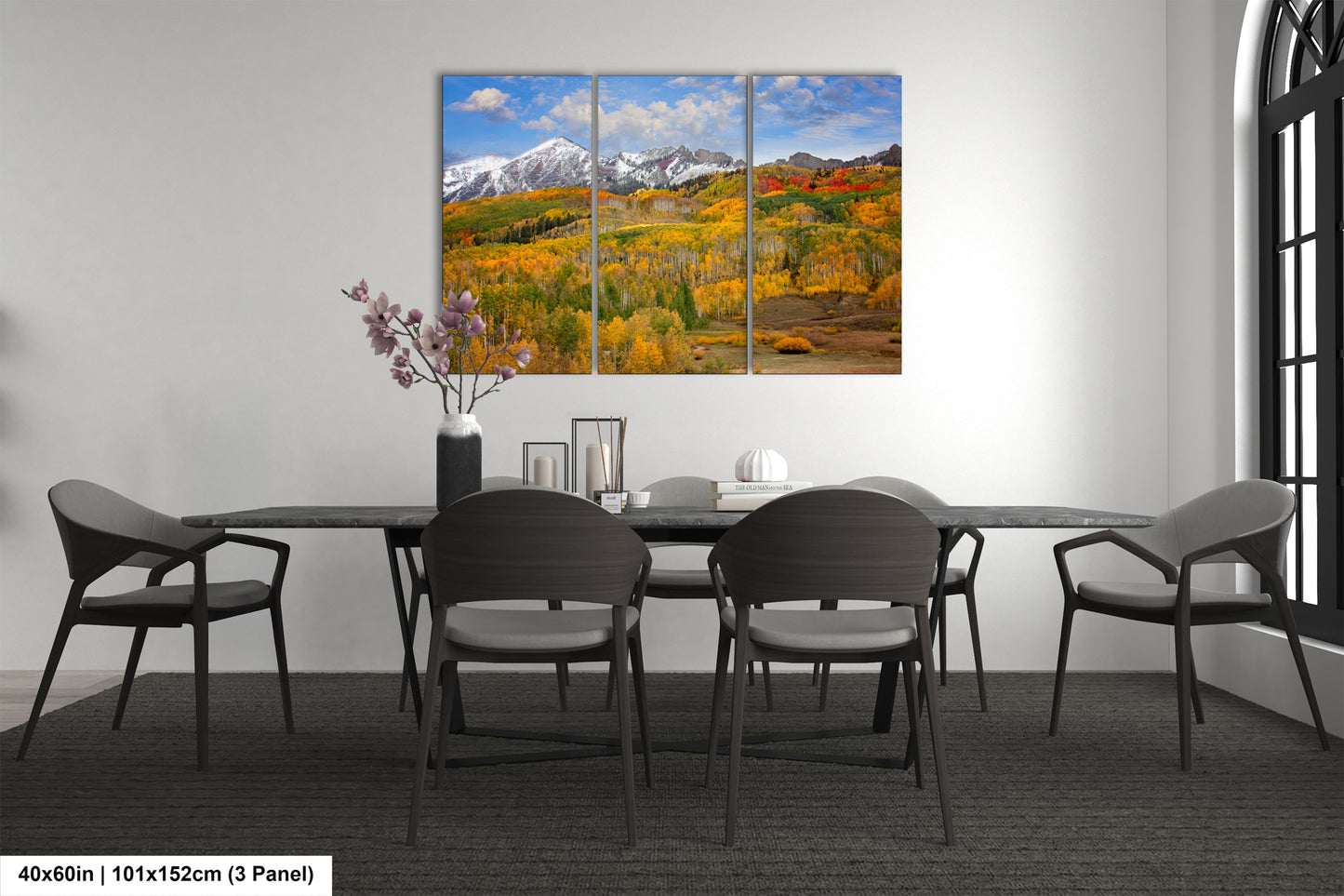 a dining room table with four chairs and a painting on the wall