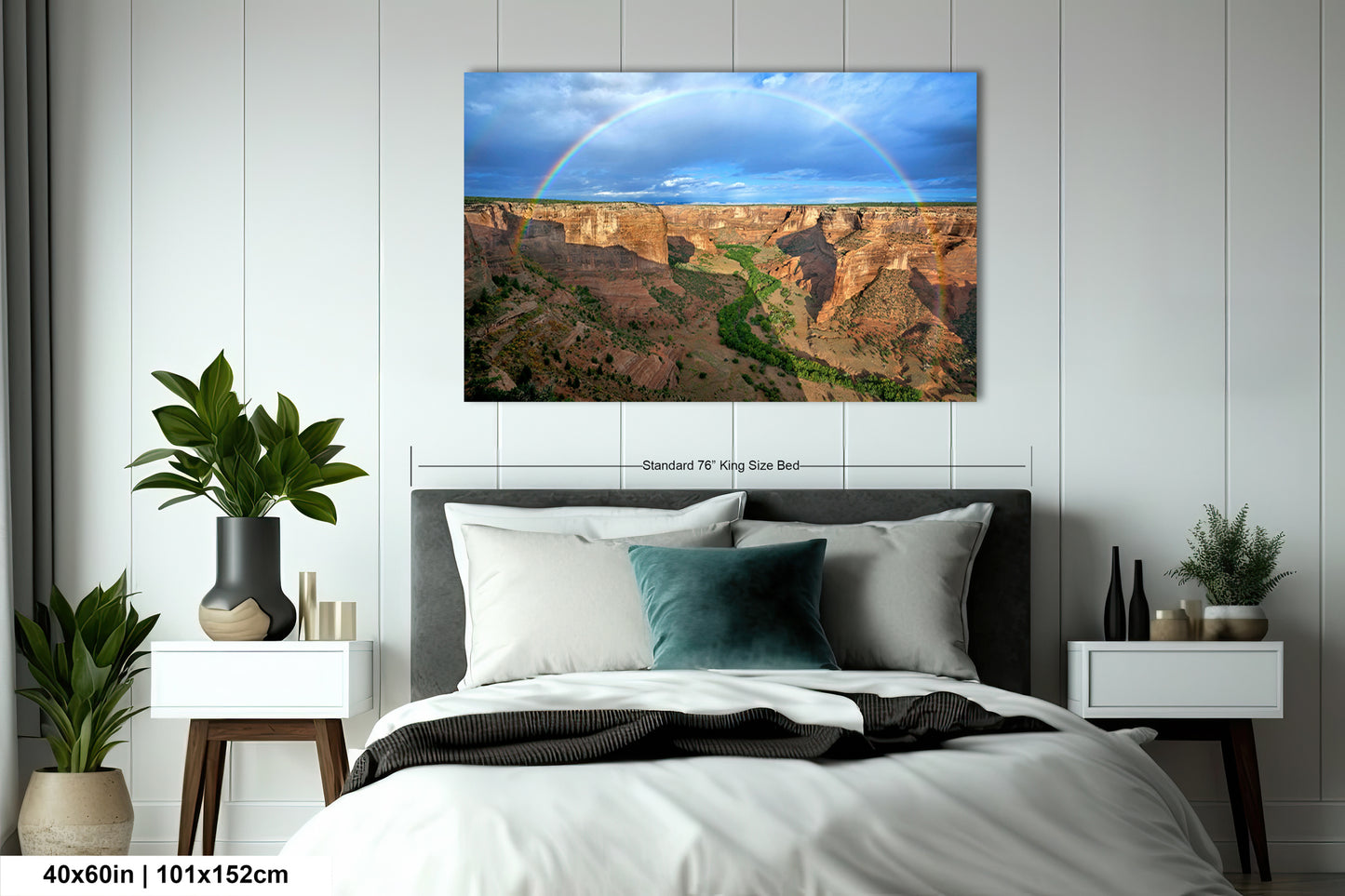 a bed room with a neatly made bed and a painting on the wall