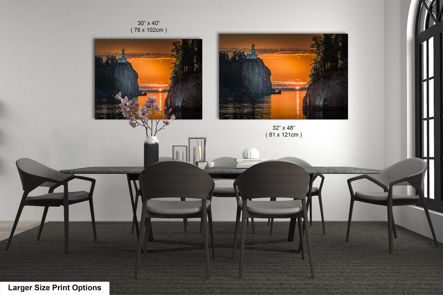 a dining room table with four chairs and a vase of flowers