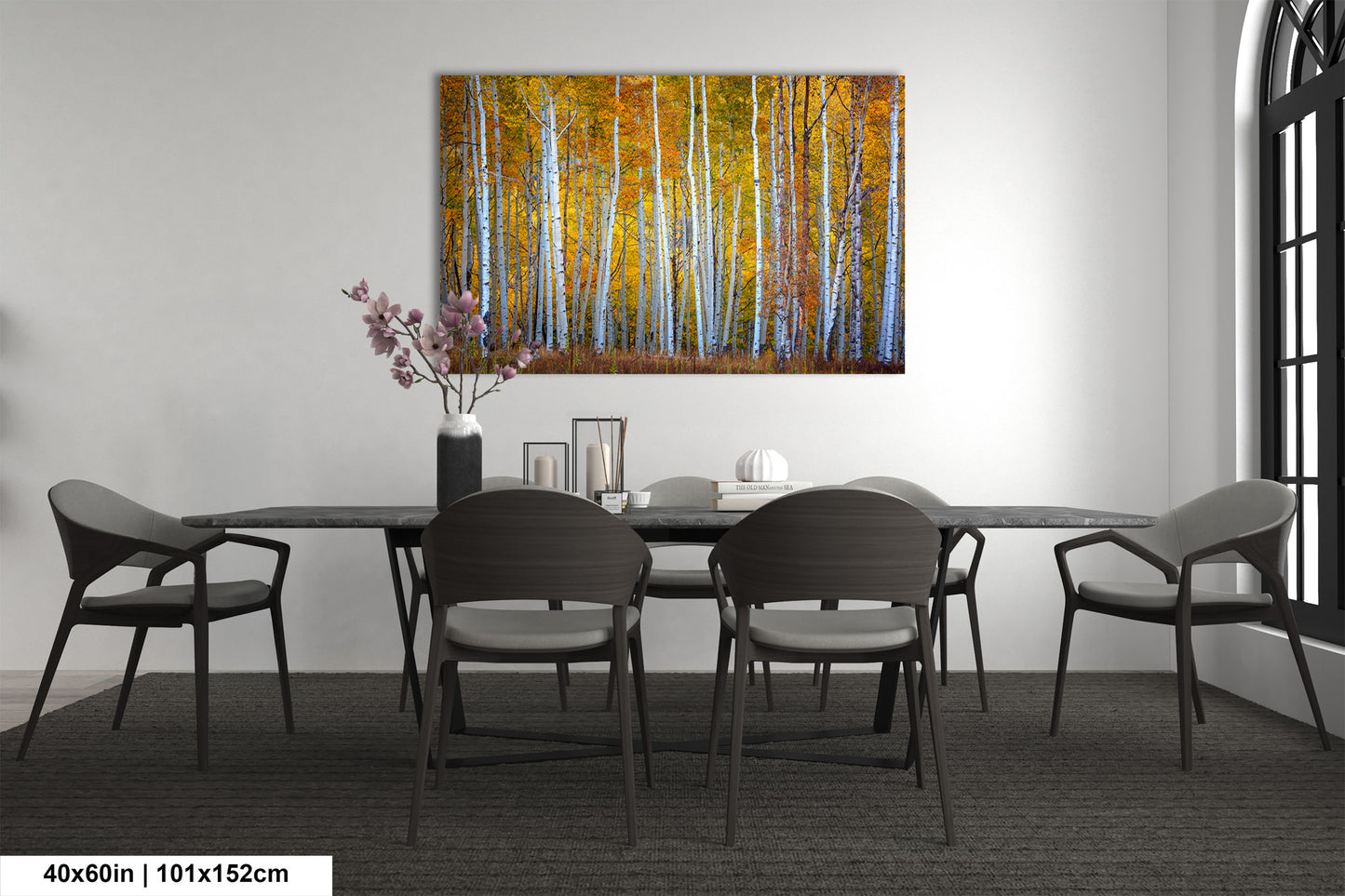 a dining room table with chairs and a painting on the wall