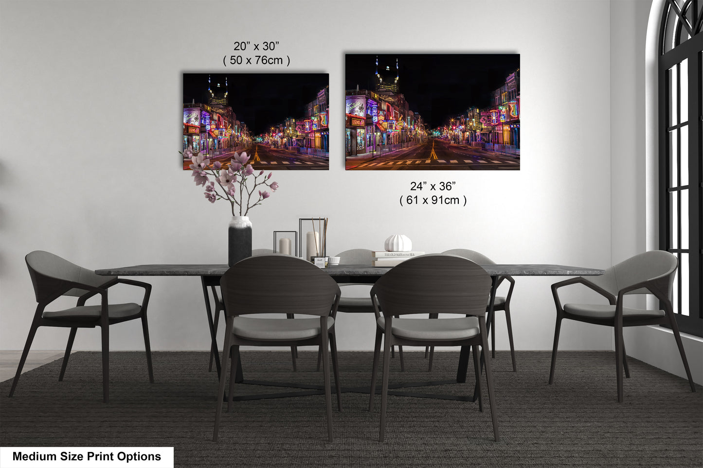 a dining table with four chairs and a vase of flowers