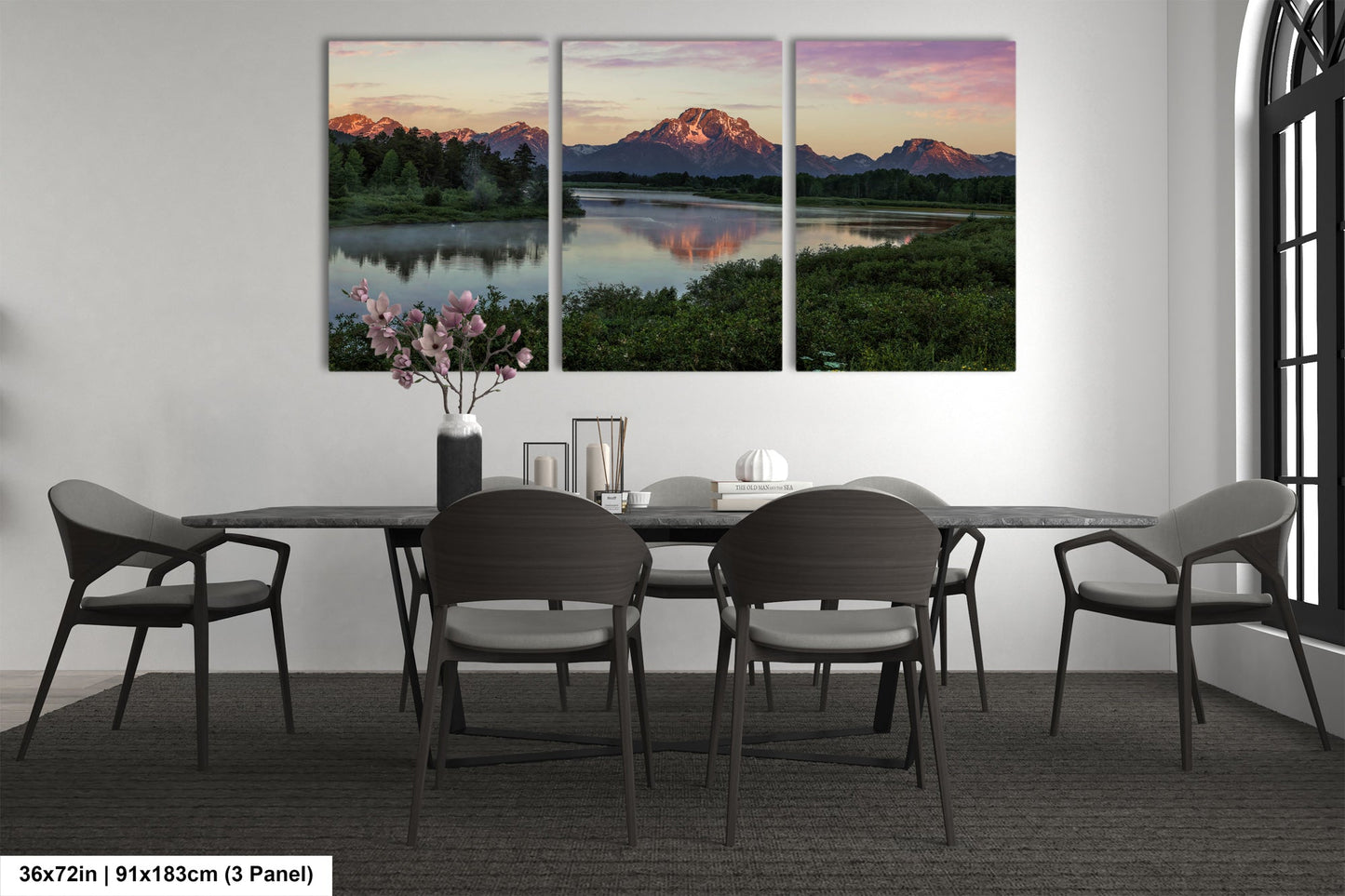 a dining room table with four chairs and a vase of flowers