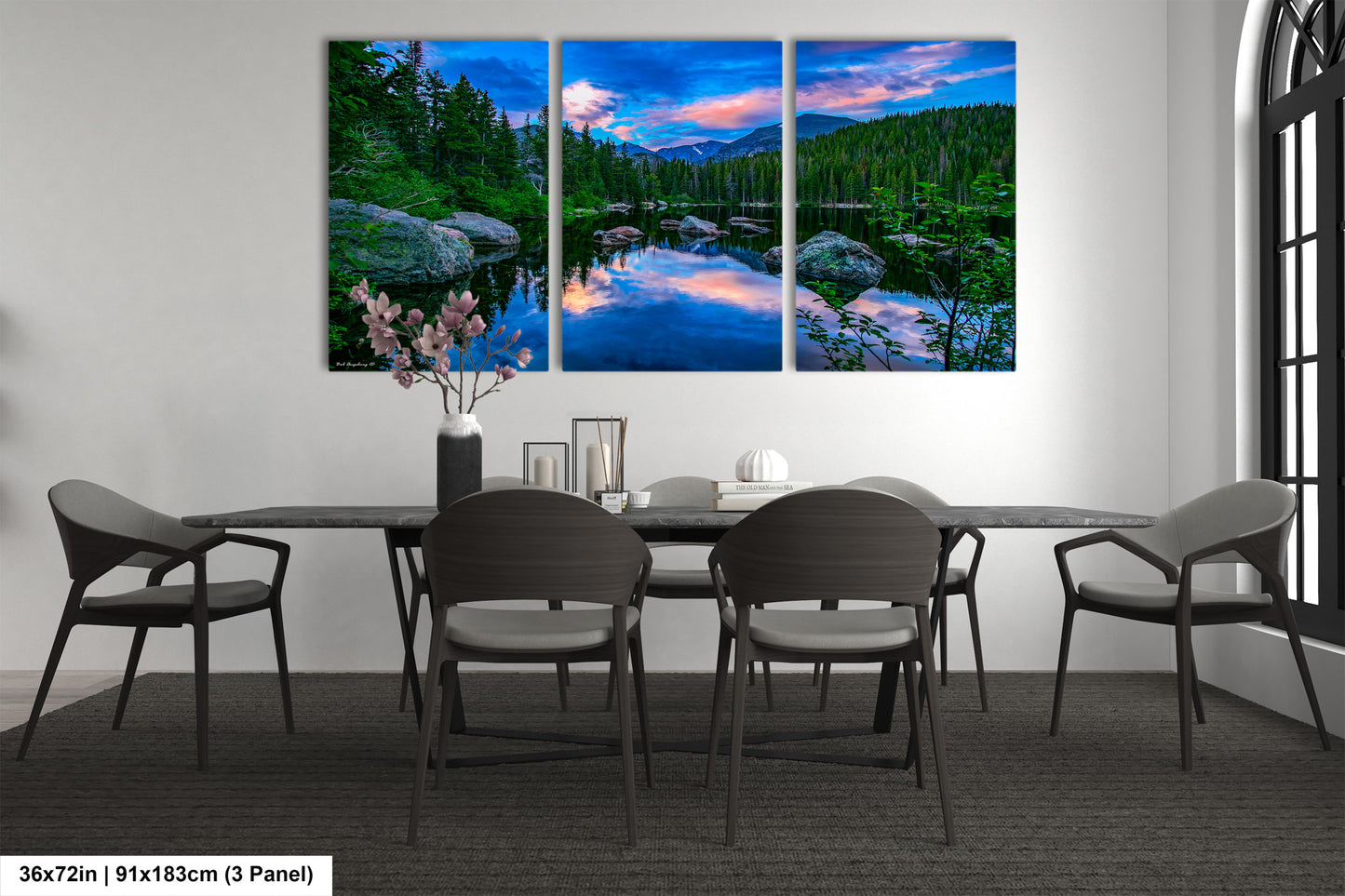 a dining room table with chairs and a painting on the wall