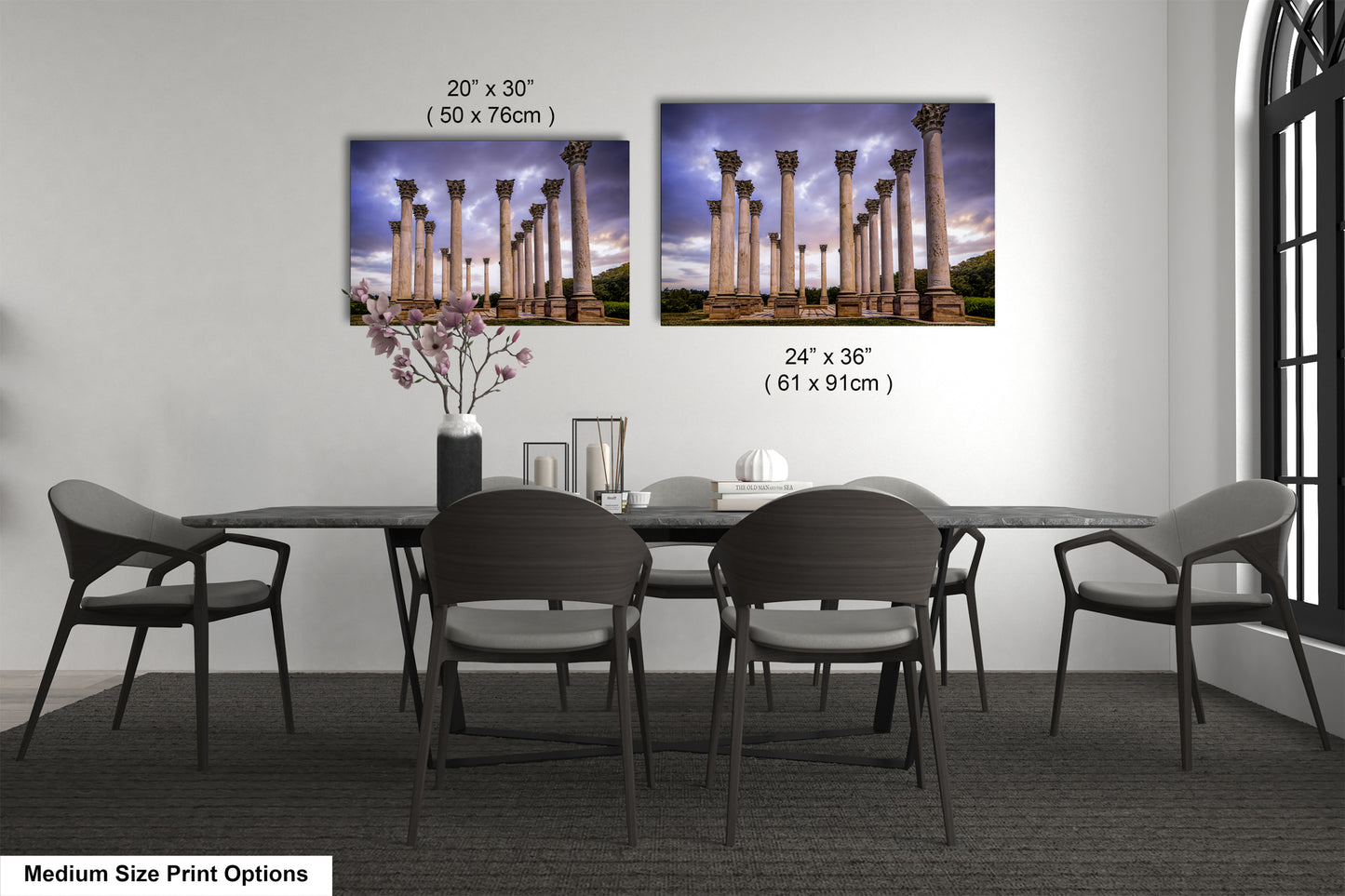 a dining table with four chairs and a vase with flowers