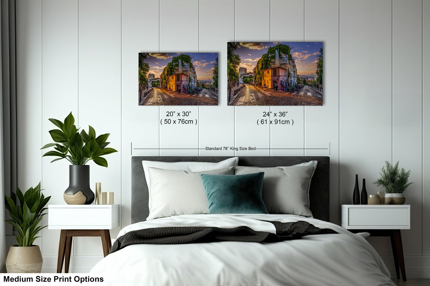 a bed with two pictures on the wall above it