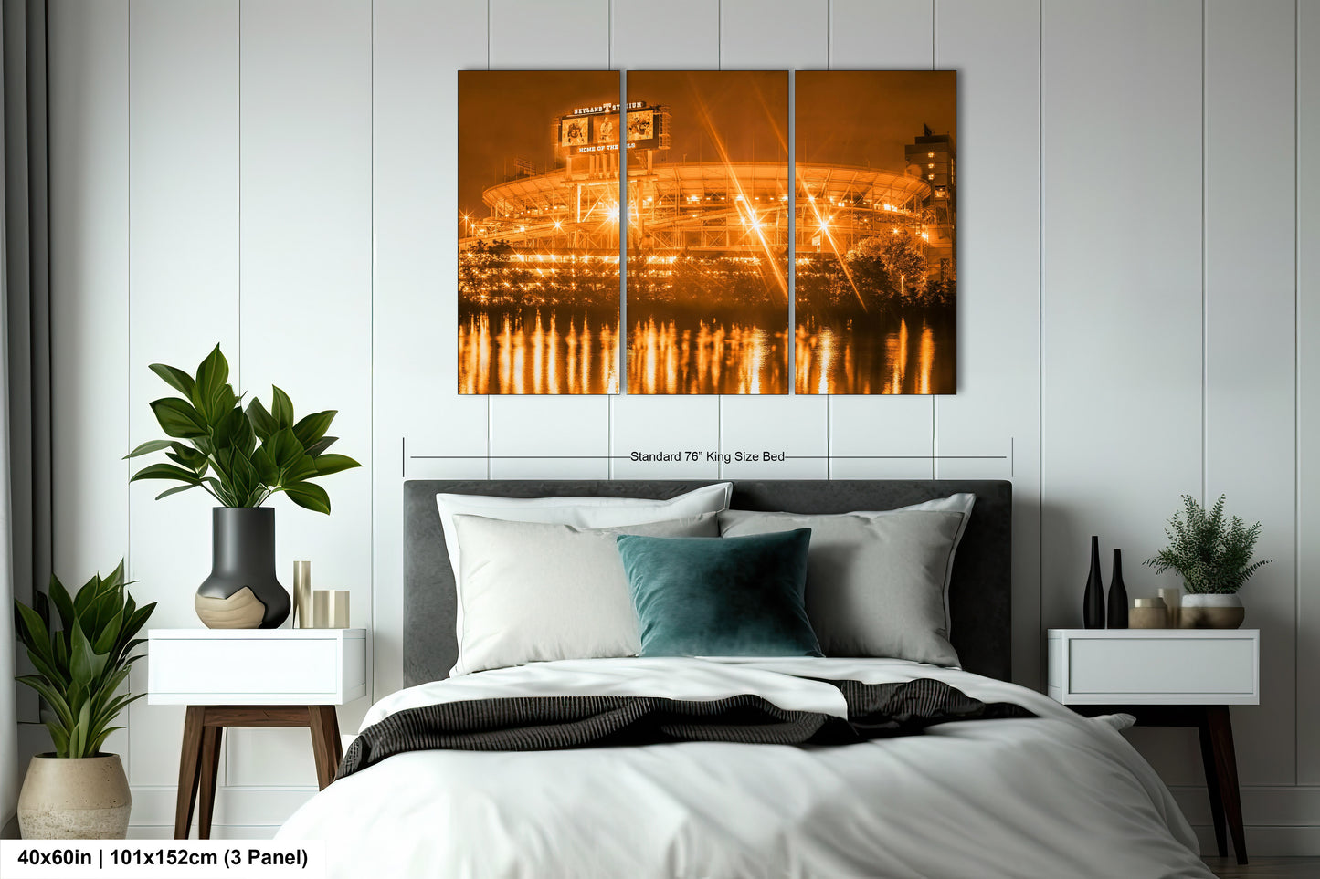 a bed with a white comforter and a painting on the wall