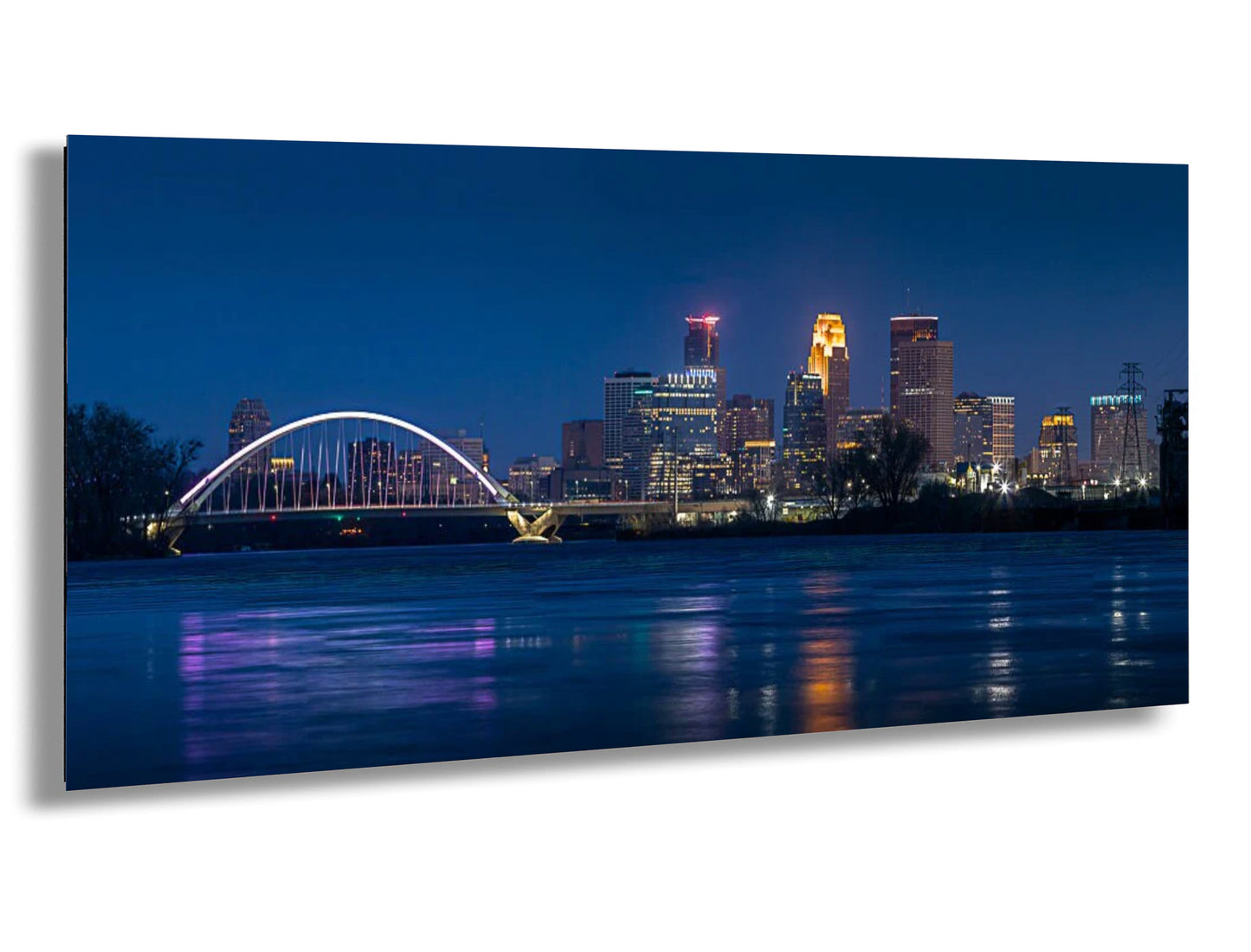 a picture of a city at night with a bridge in the foreground