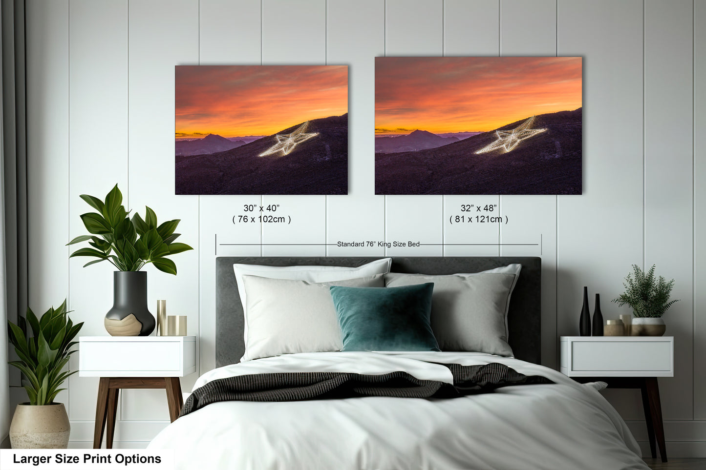 a bed with two pictures on the wall above it