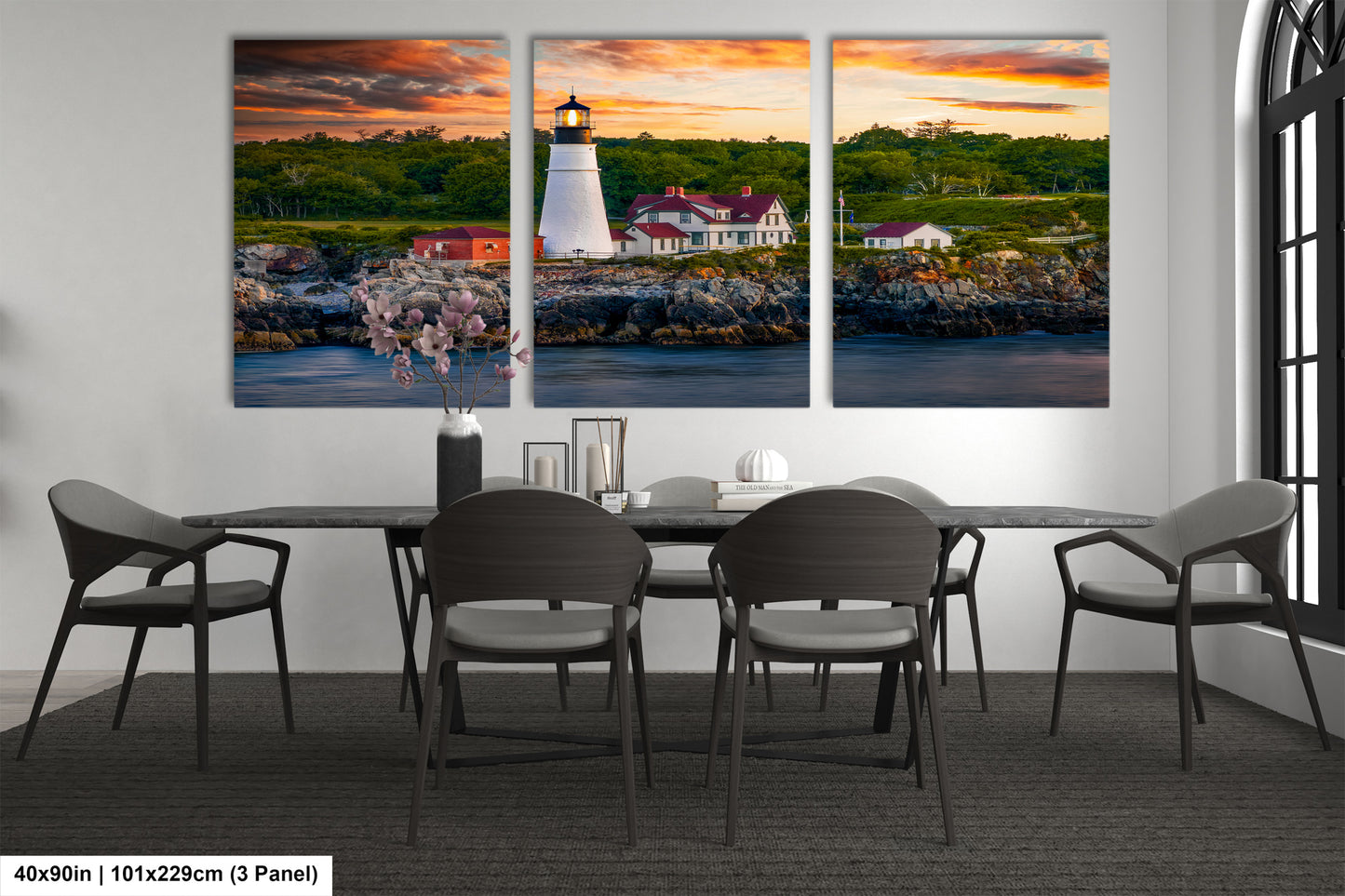 a dining room table with four chairs and a painting of a lighthouse