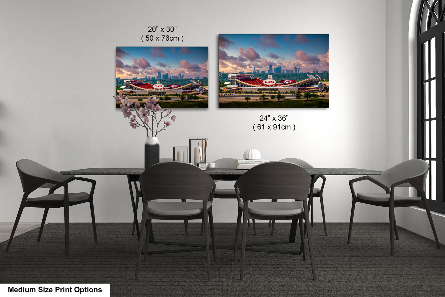 a dining room table with four chairs and a vase with flowers
