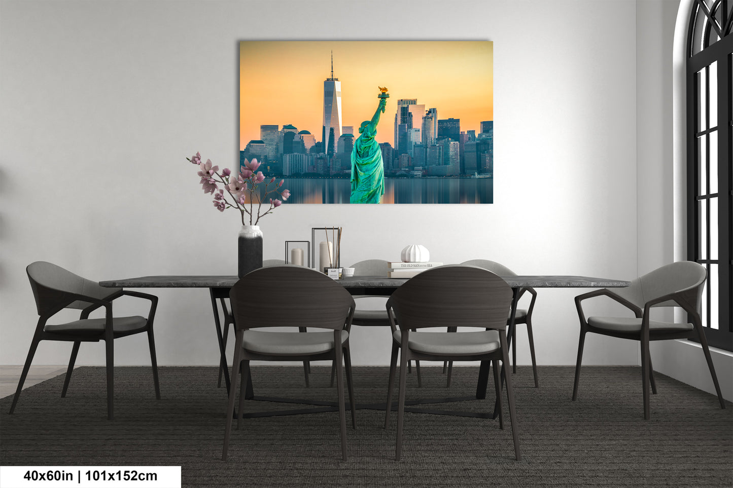 a dining room table with chairs and a painting of the statue of liberty