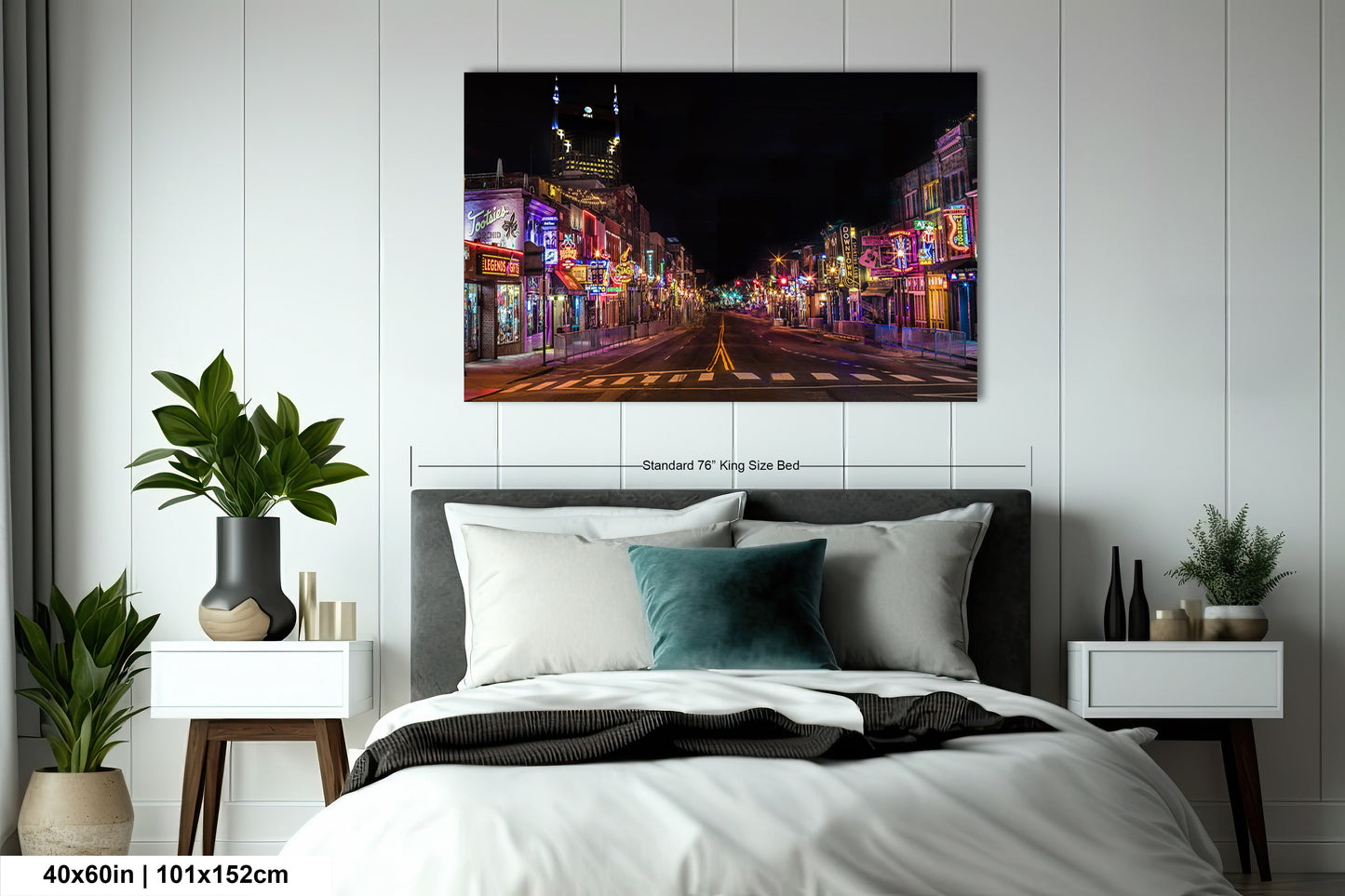 a bed in a room with a painting on the wall