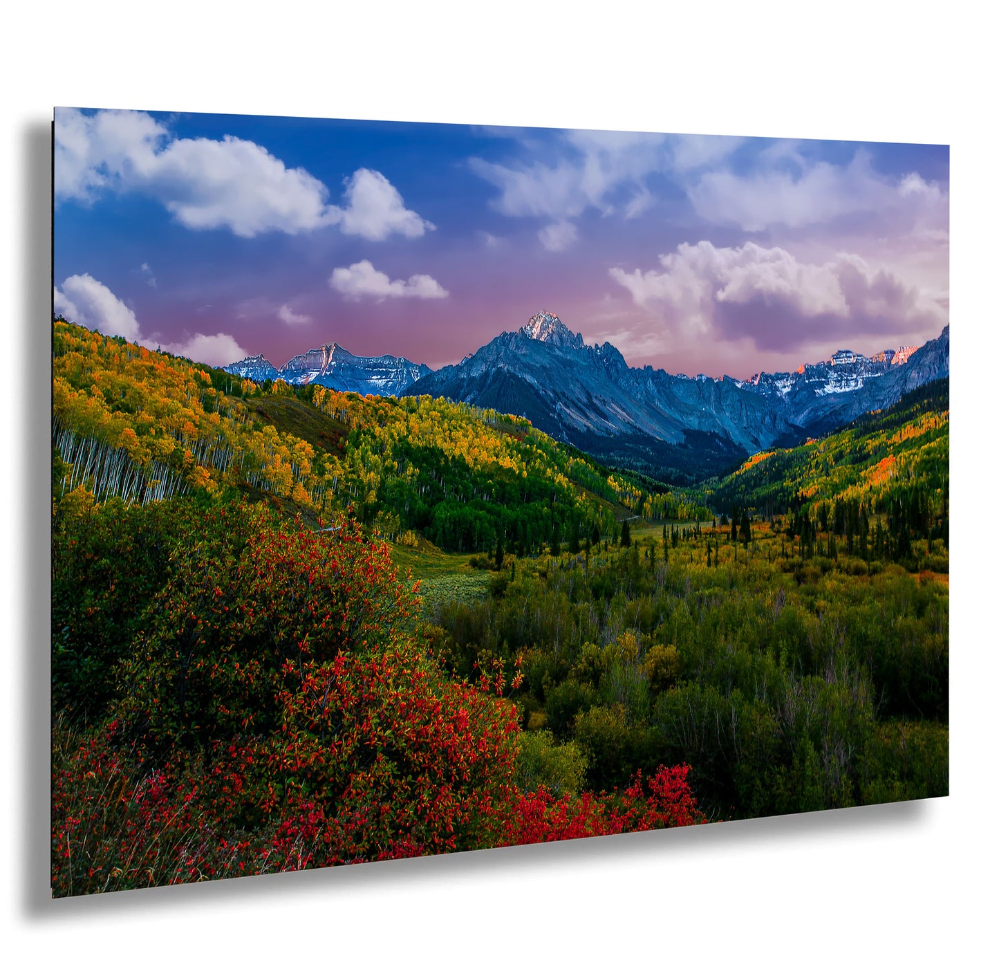a scenic view of a mountain range in autumn