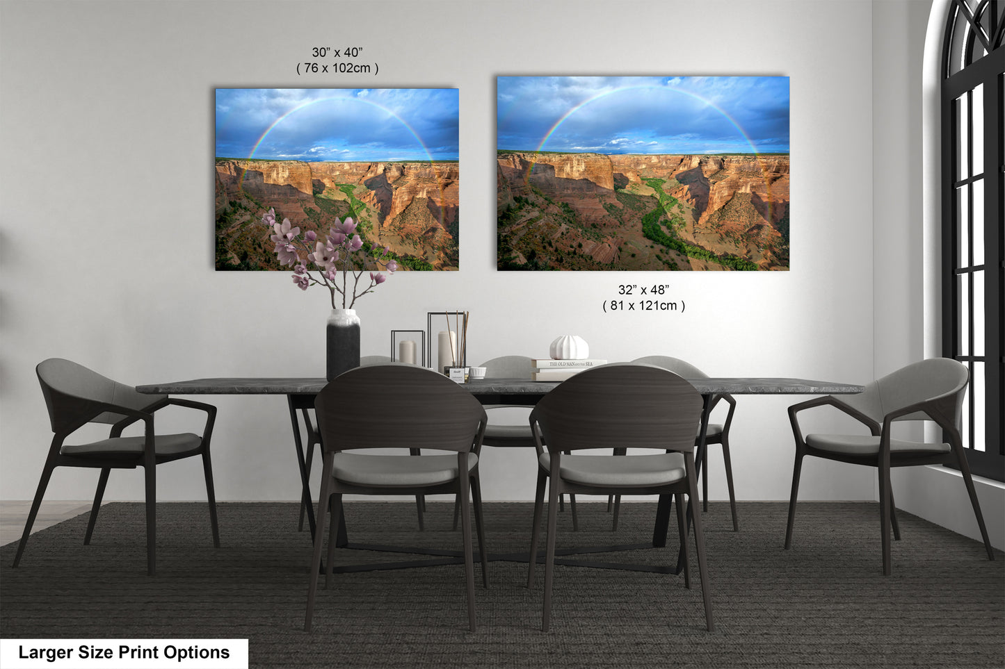a dining room table with four chairs and a painting of a rainbow