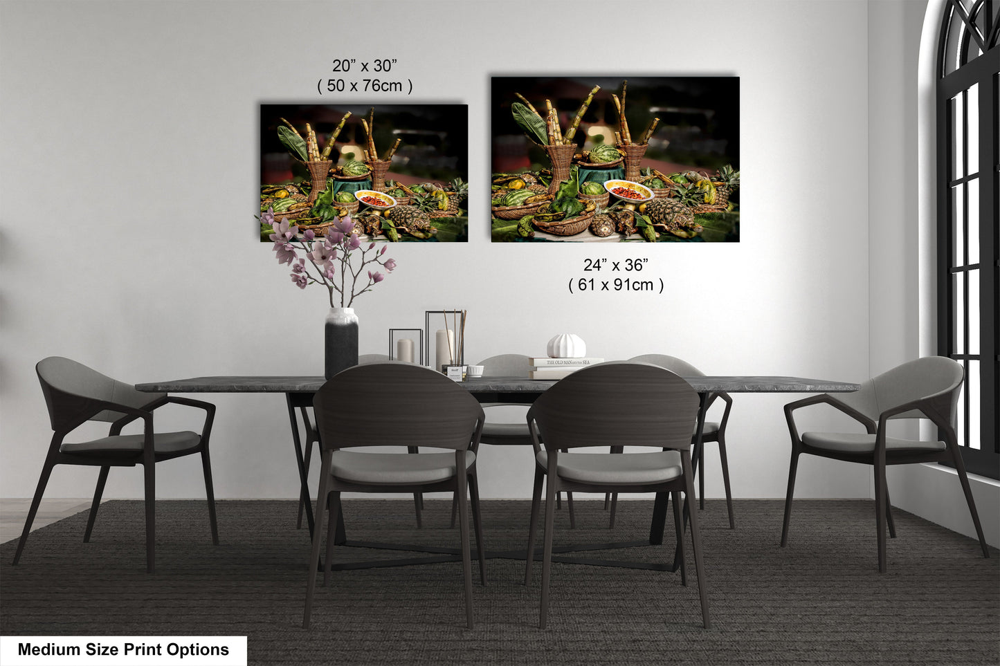 a dining room table with four chairs and a vase of flowers