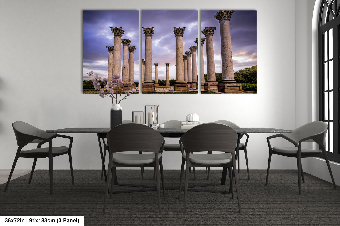 a dining room table with four chairs and four paintings on the wall