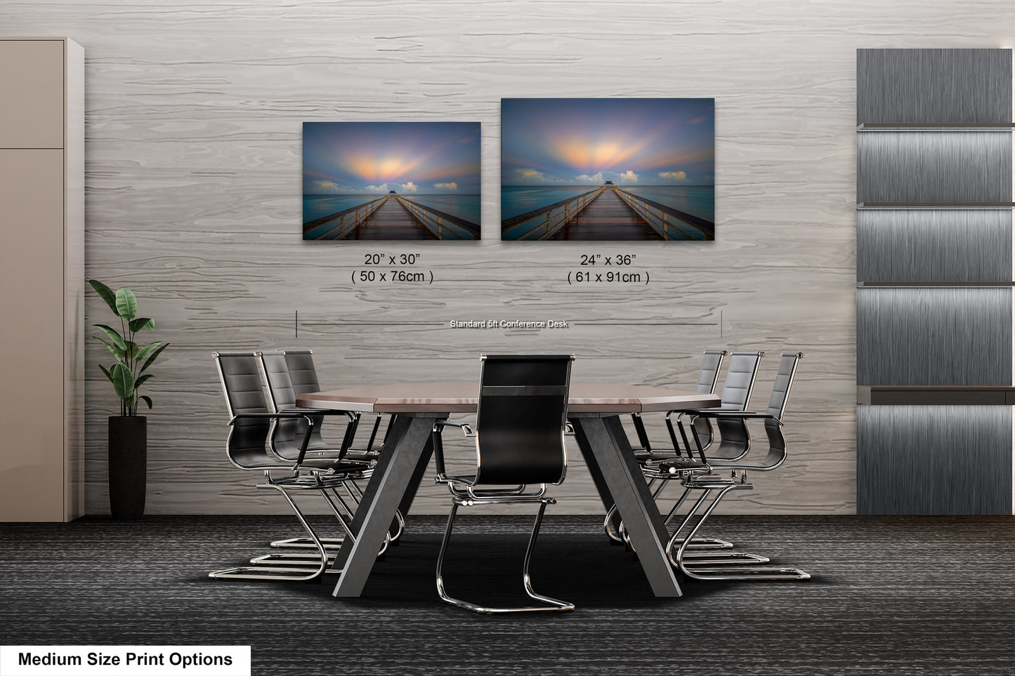 a dining room table with four chairs and two pictures on the wall