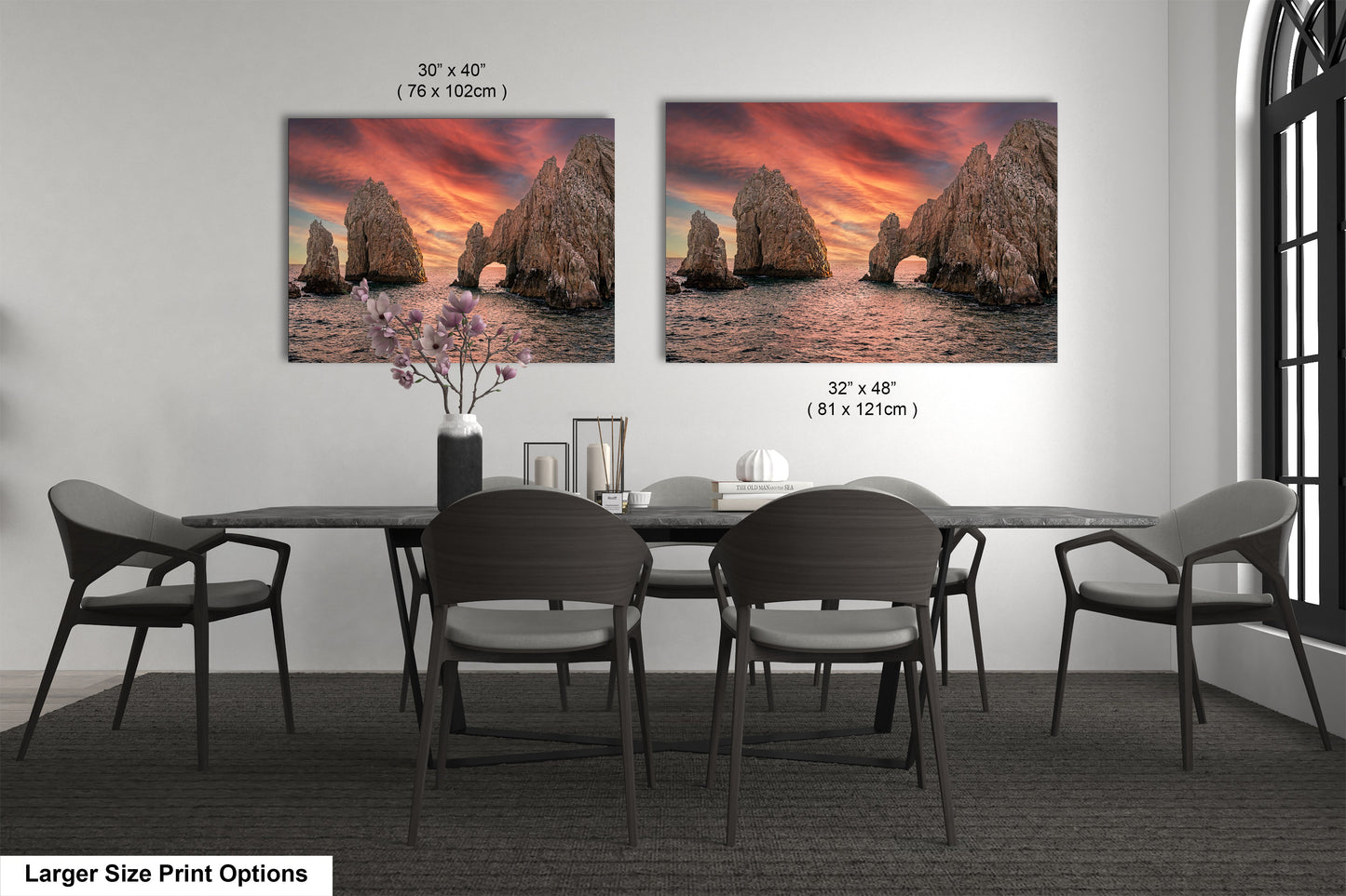 a dining room table with four chairs and two pictures on the wall