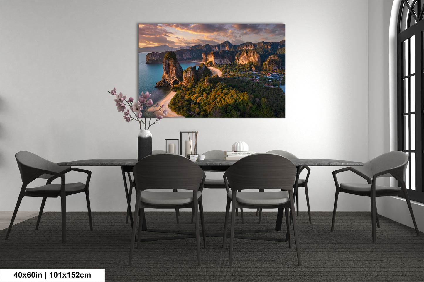 a dining room table with chairs and a painting on the wall