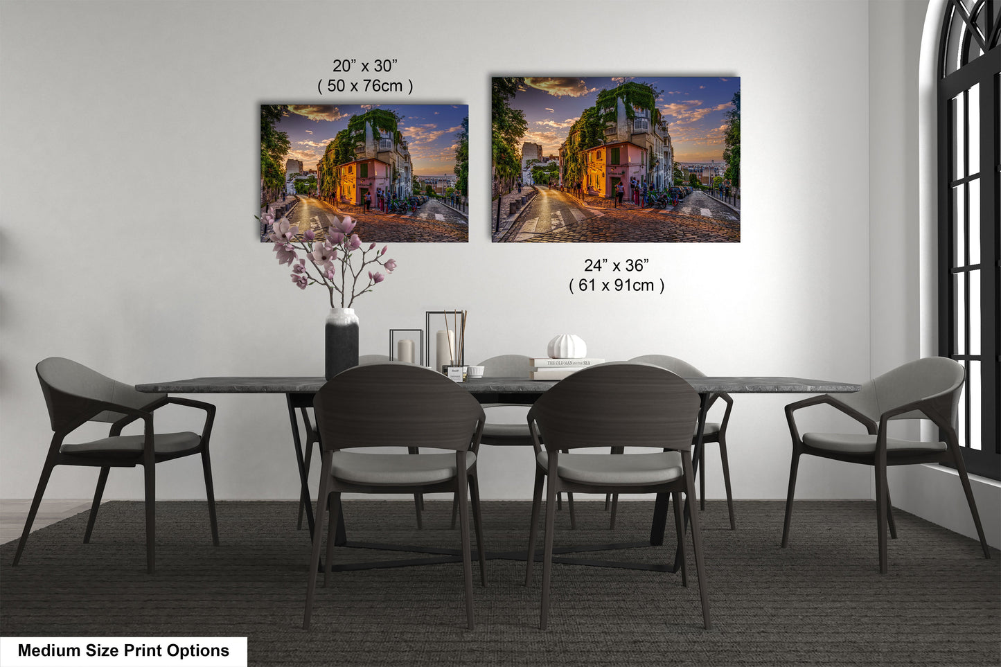 a dining table with four chairs and a vase of flowers