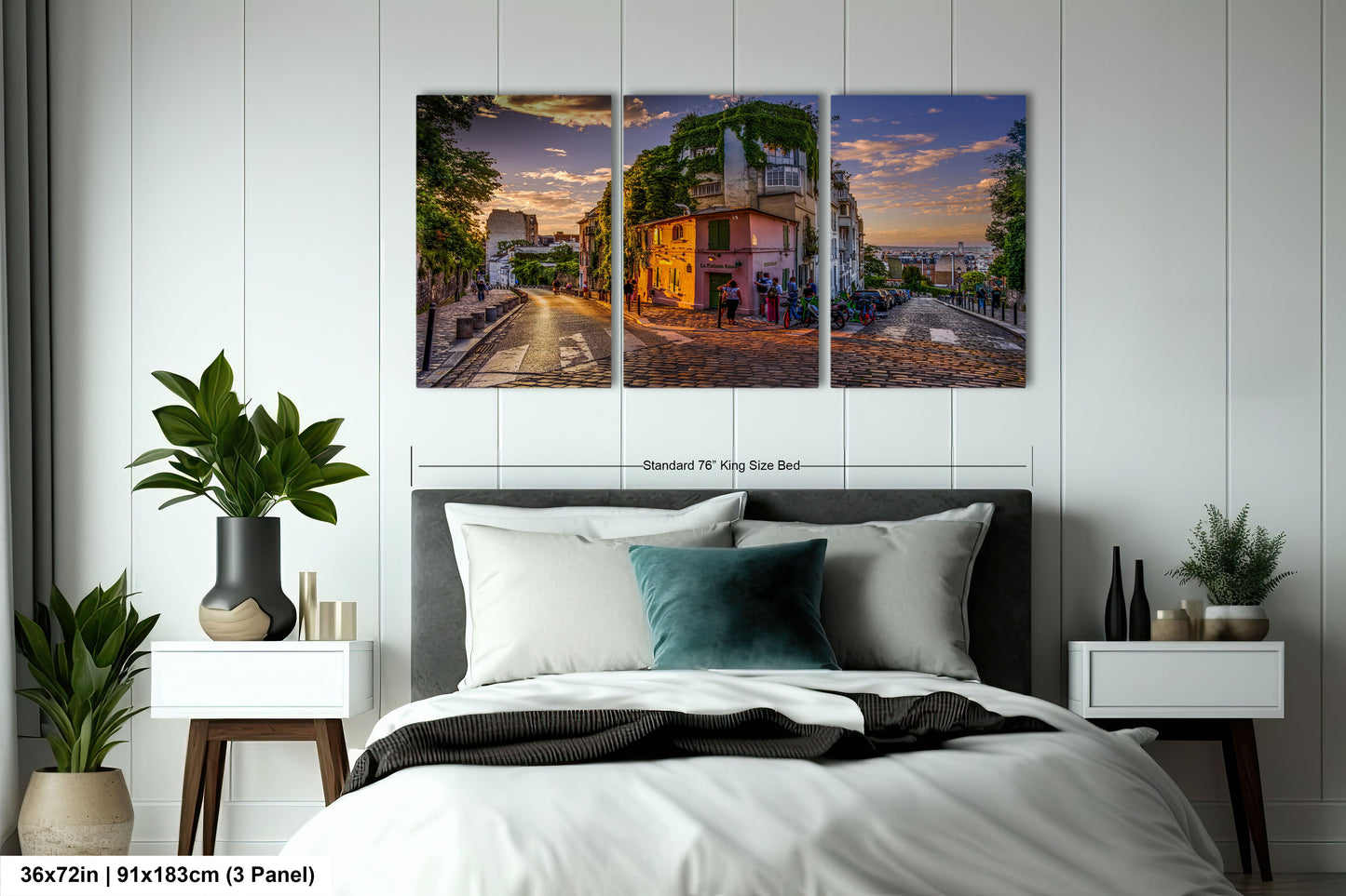 a bedroom with a bed and two paintings on the wall