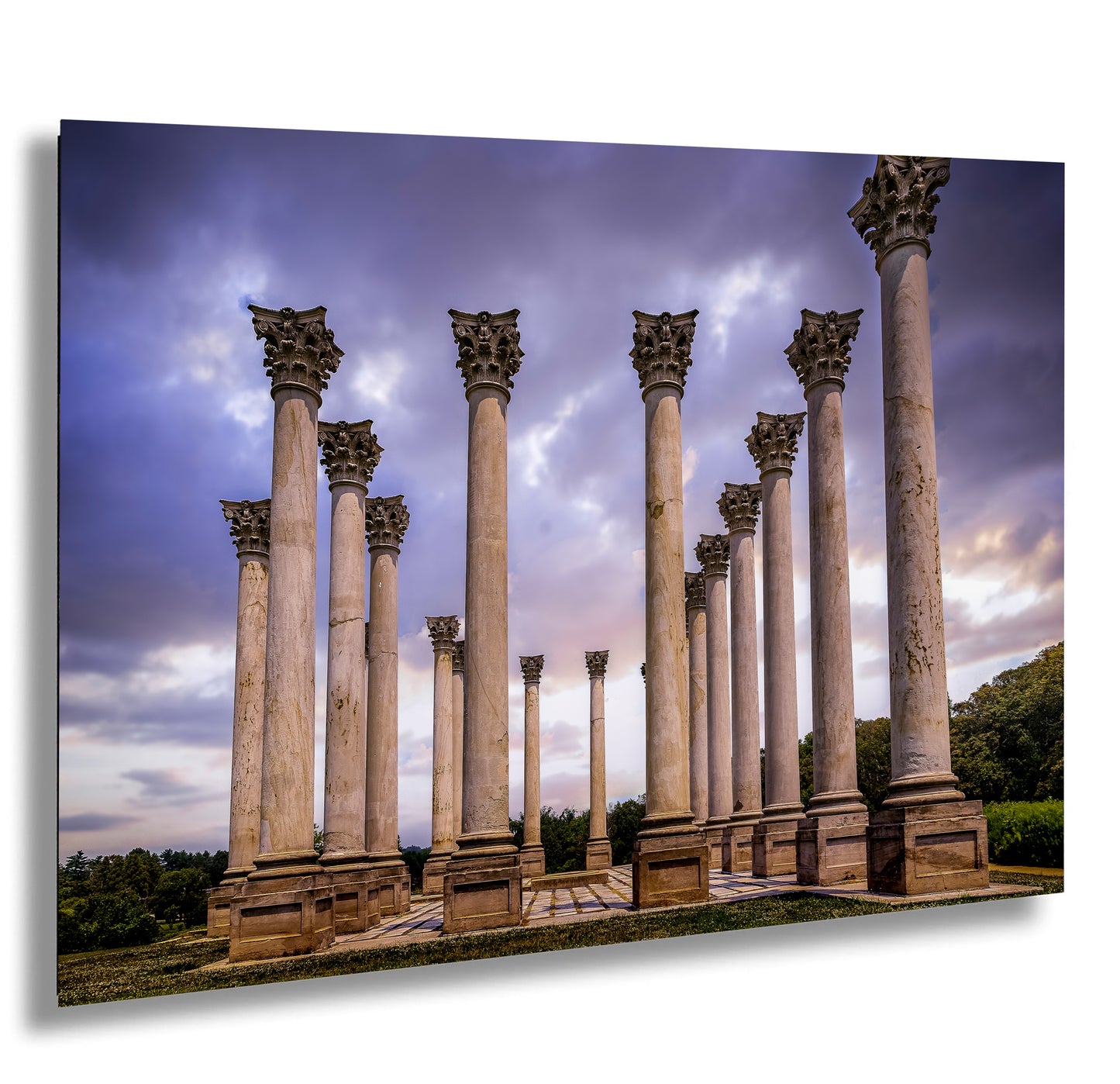 a row of stone pillars in front of a cloudy sky