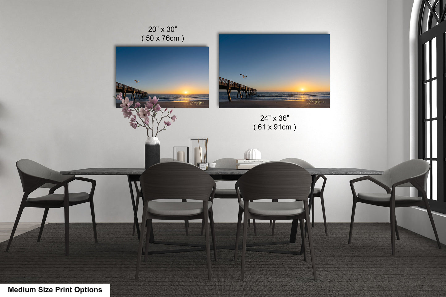 a dining table with four chairs and a vase of flowers