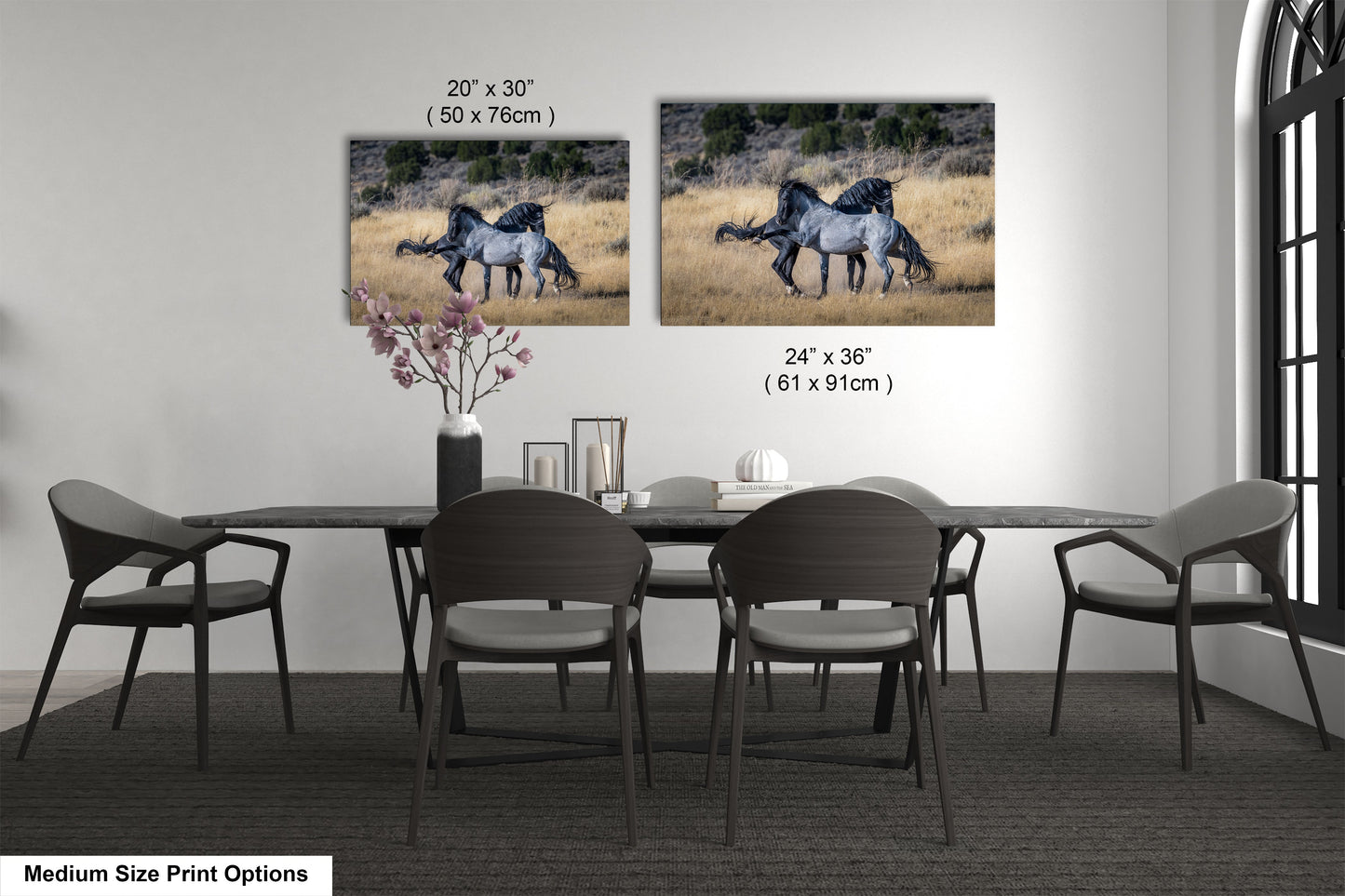 a dining room table with four chairs and two pictures of horses on the wall