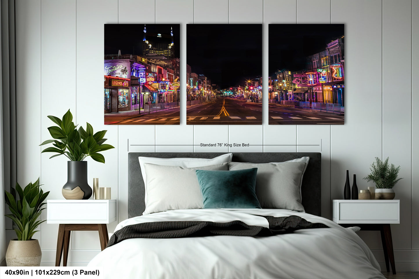 a bed room with a neatly made bed and two paintings on the wall