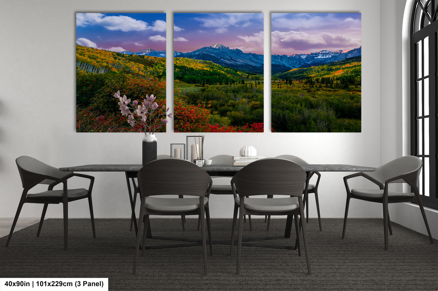 a dining room table with four chairs and a painting on the wall
