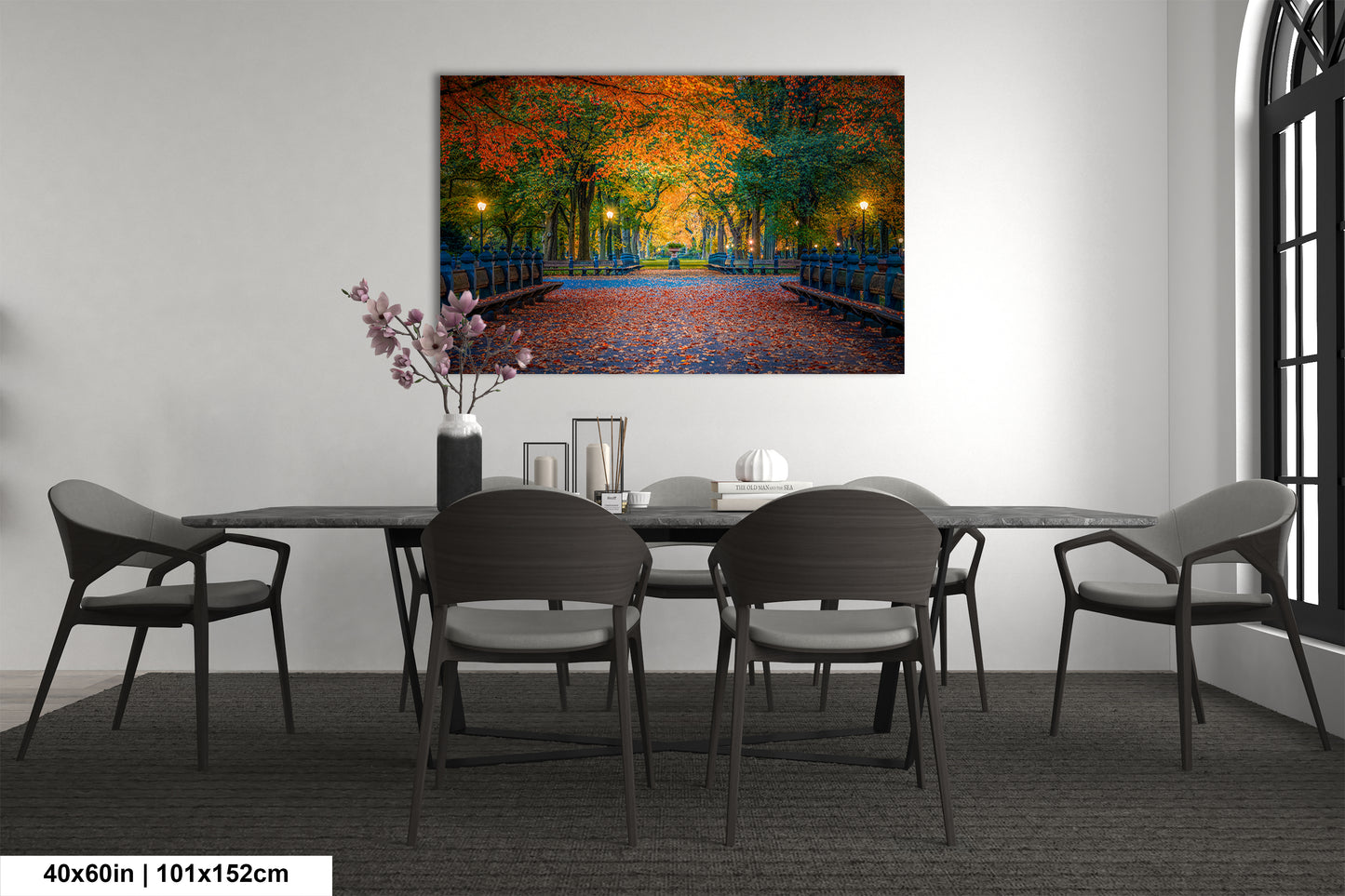 a dining room table with chairs and a painting on the wall