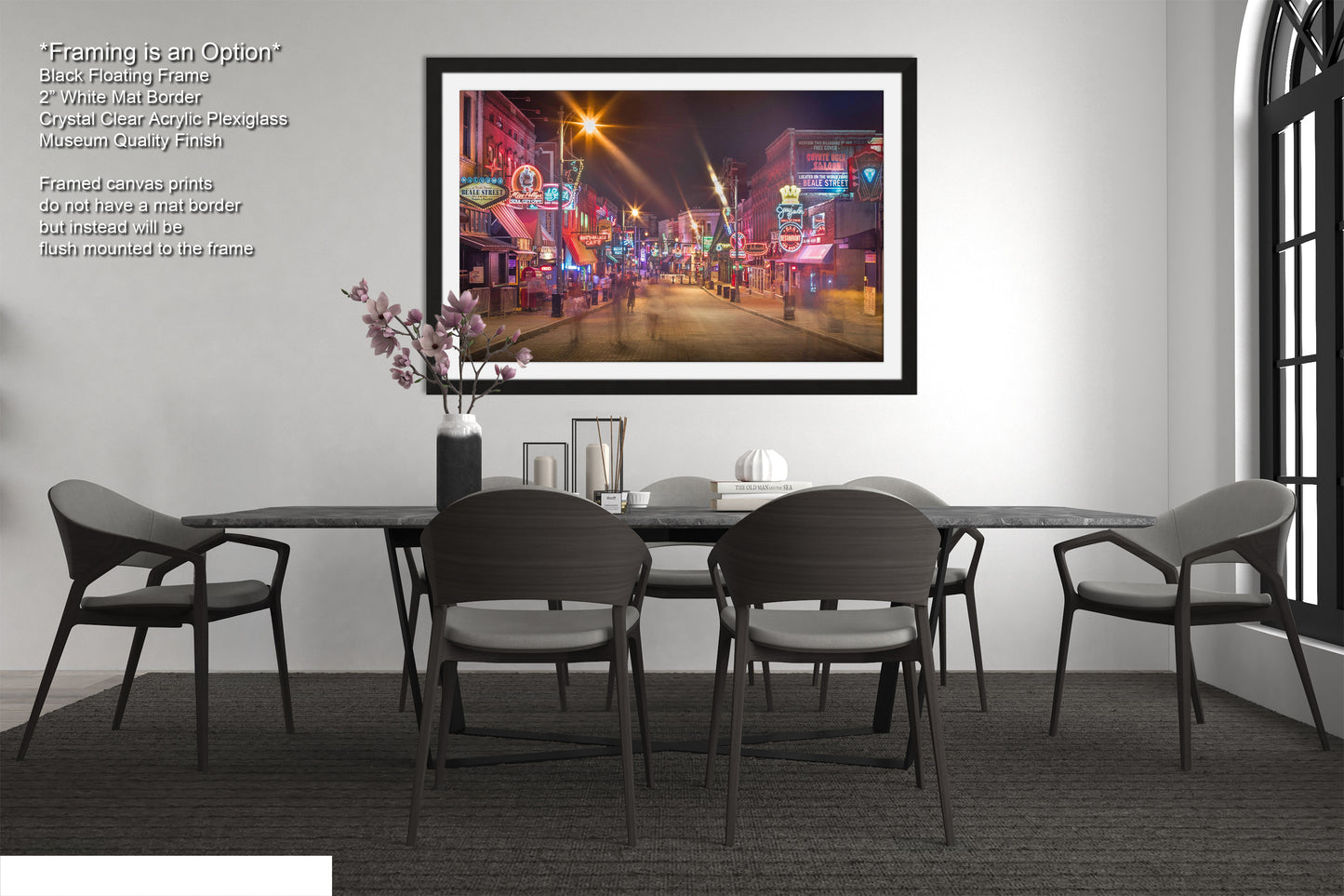 a room with a table and chairs and a picture hanging on the wall