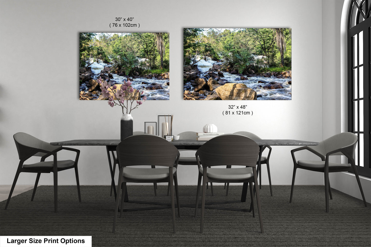 a dining room table with four chairs and two pictures on the wall
