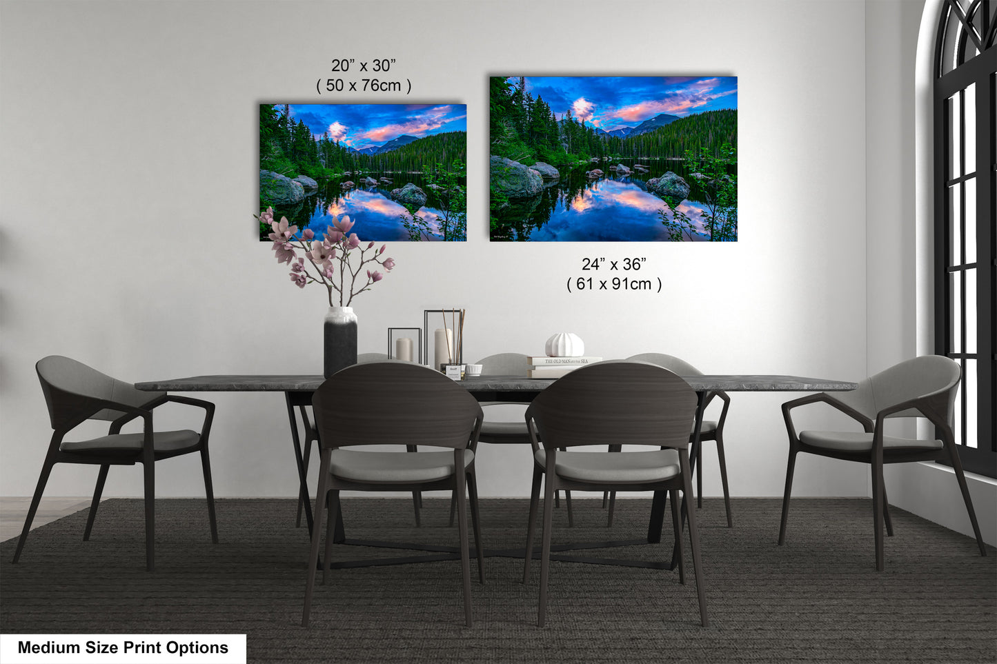 a dining table with four chairs and a vase of flowers