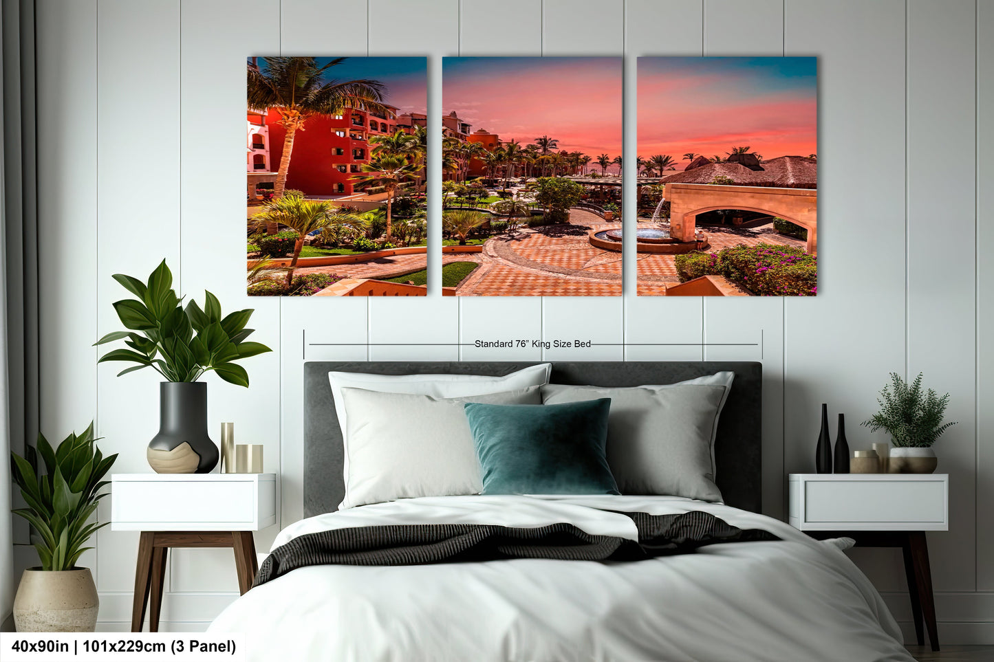 a bedroom with a bed and two paintings on the wall