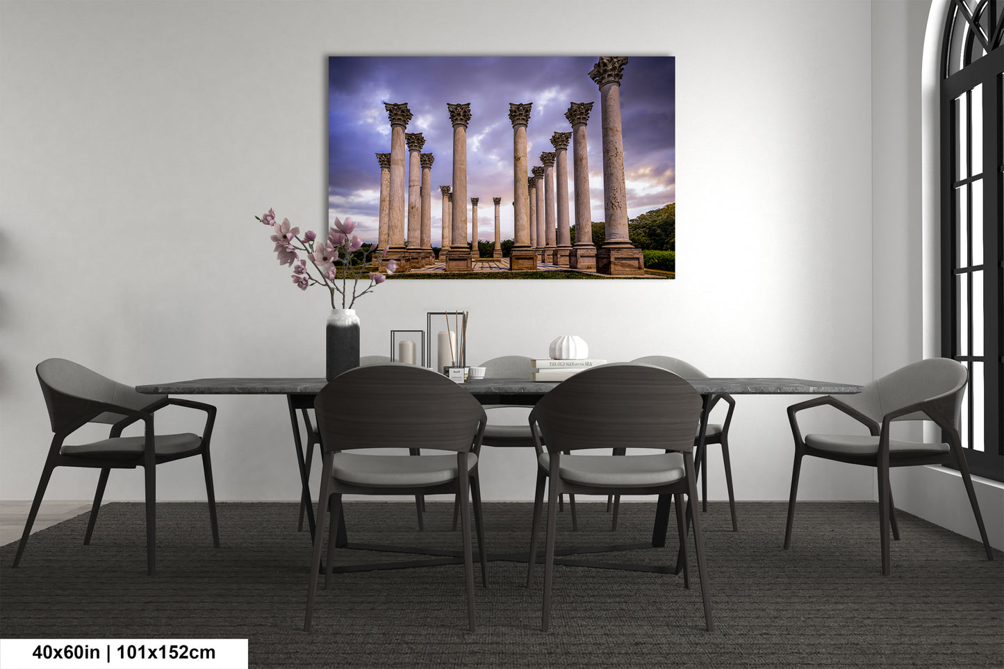 a room with a table and chairs and a painting on the wall