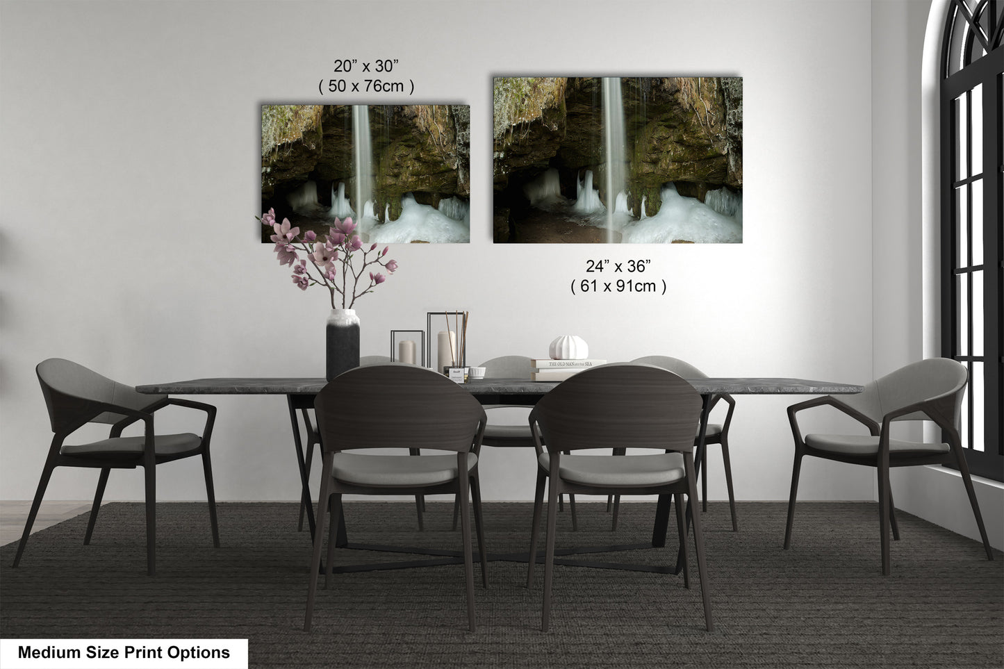 a dining room table with four chairs and a vase with flowers