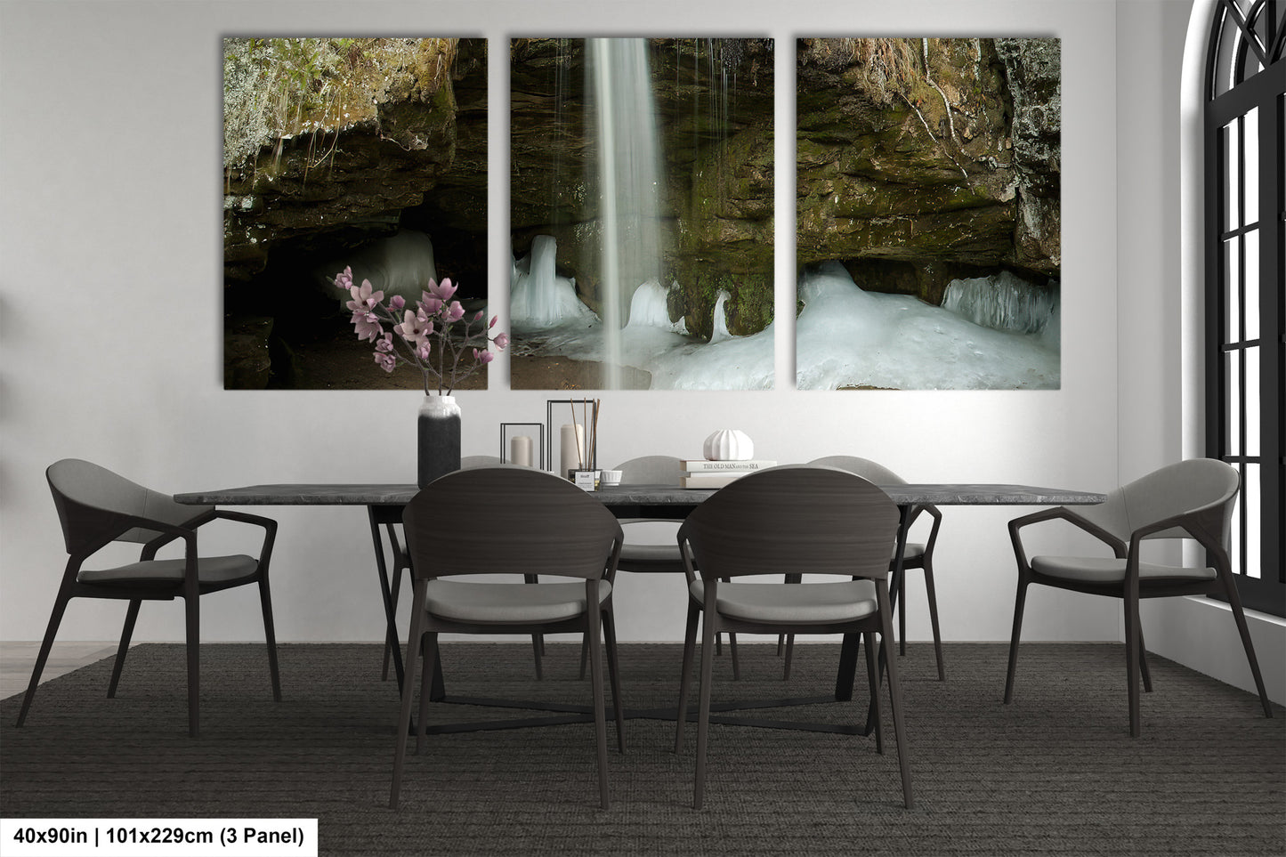 a dining room table with four chairs and a waterfall in the background