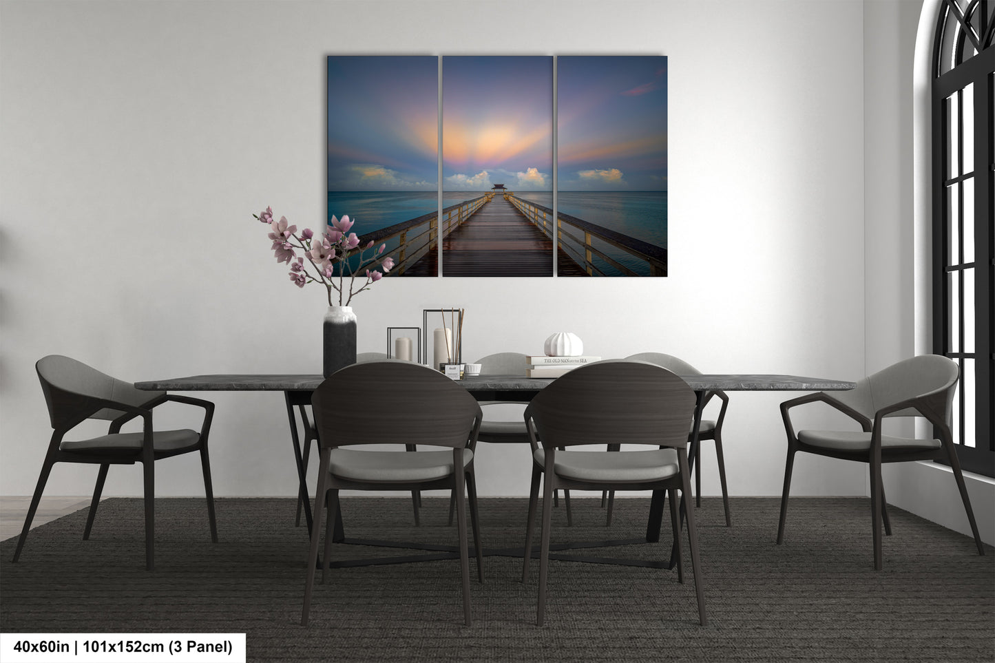 a dining room table with chairs and a painting on the wall