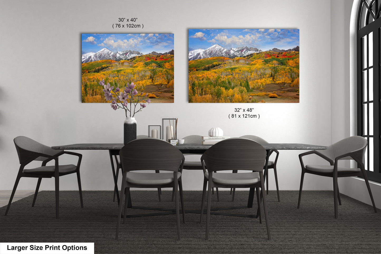 a dining room table with four chairs and a vase of flowers