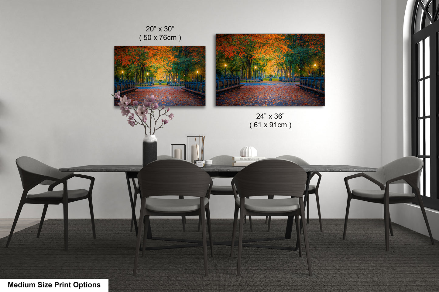 a dining table with four chairs and a vase of flowers