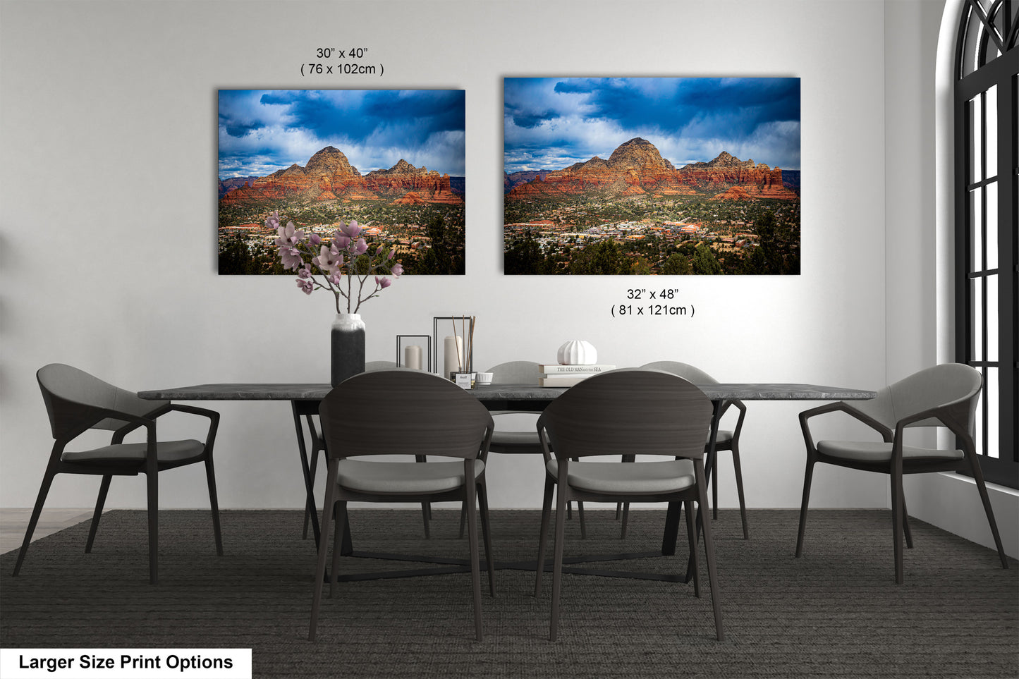 a dining room table with four chairs and a vase of flowers
