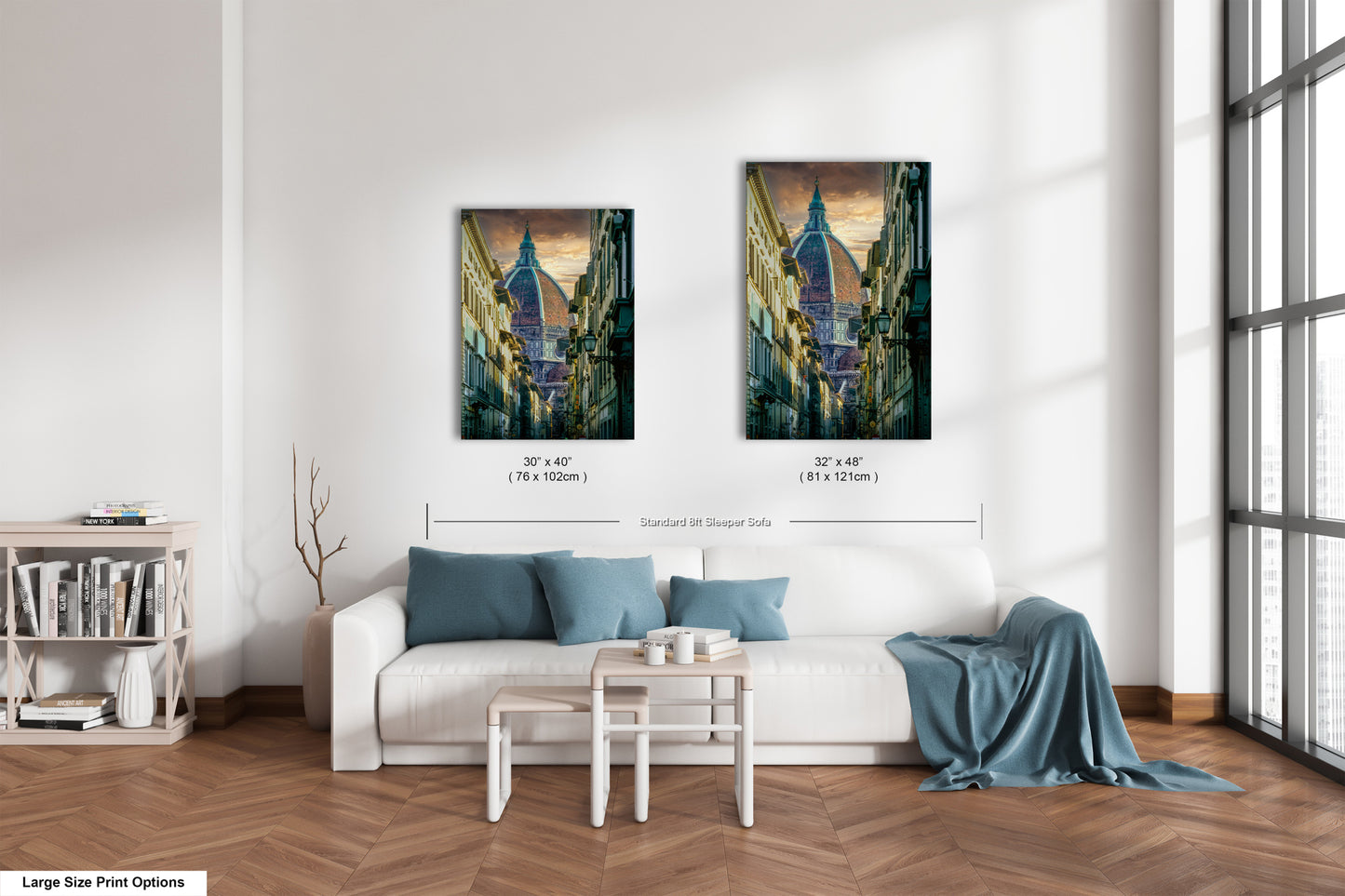a living room with a white couch and two paintings on the wall