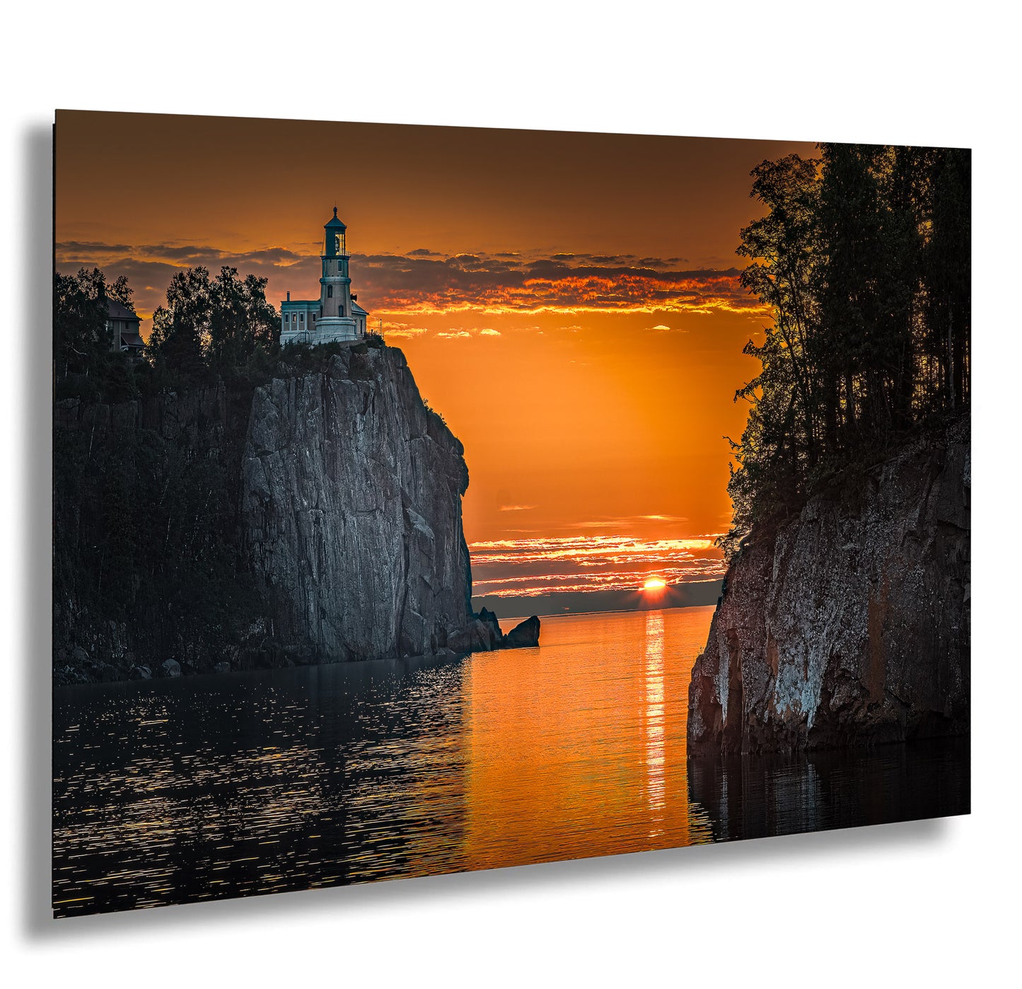 a lighthouse sitting on top of a cliff next to a body of water