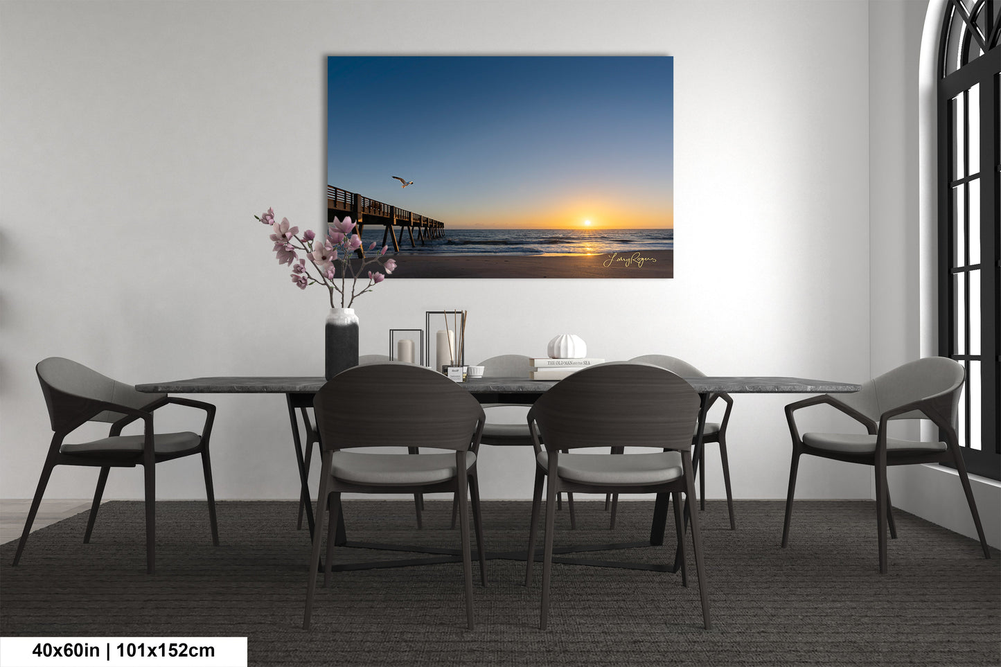a room with a table and chairs and a painting on the wall