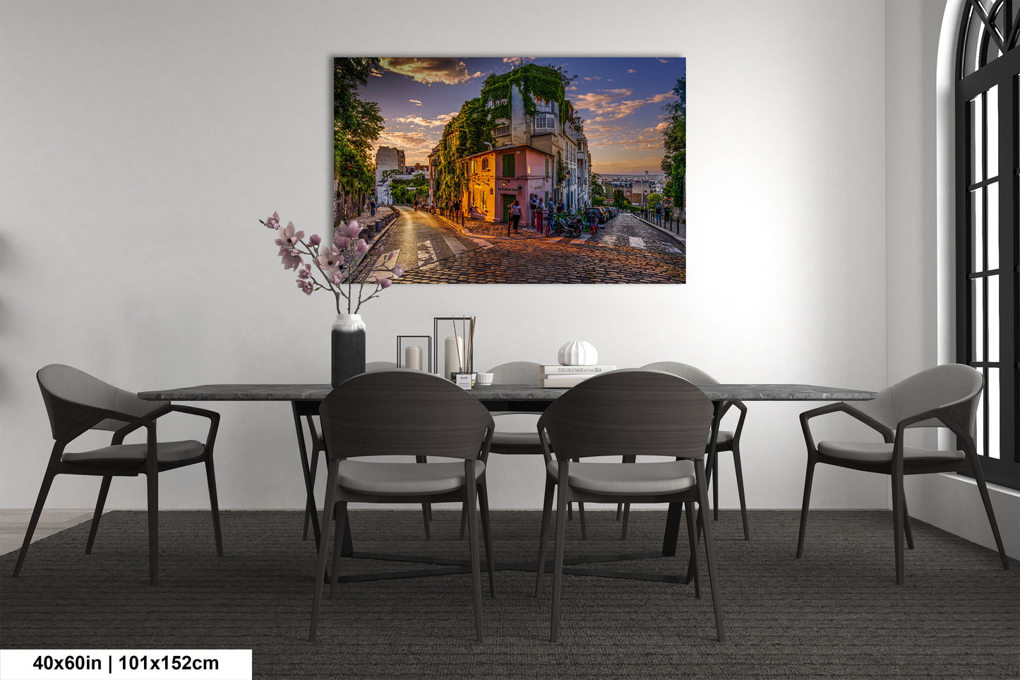 a room with a table and chairs and a painting on the wall