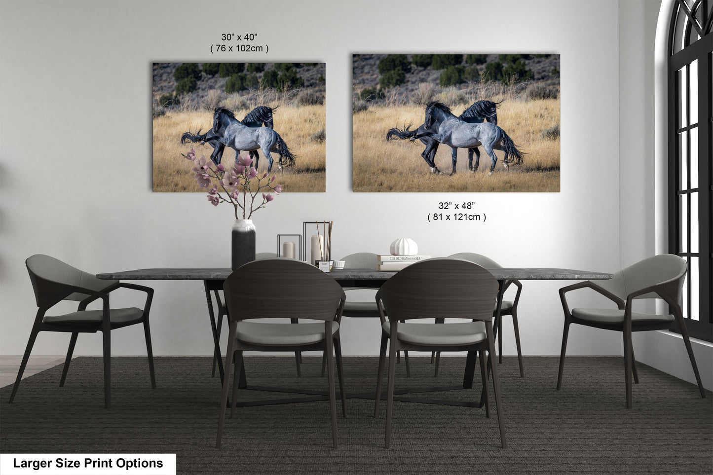 a dining room table with chairs and two pictures of horses on the wall