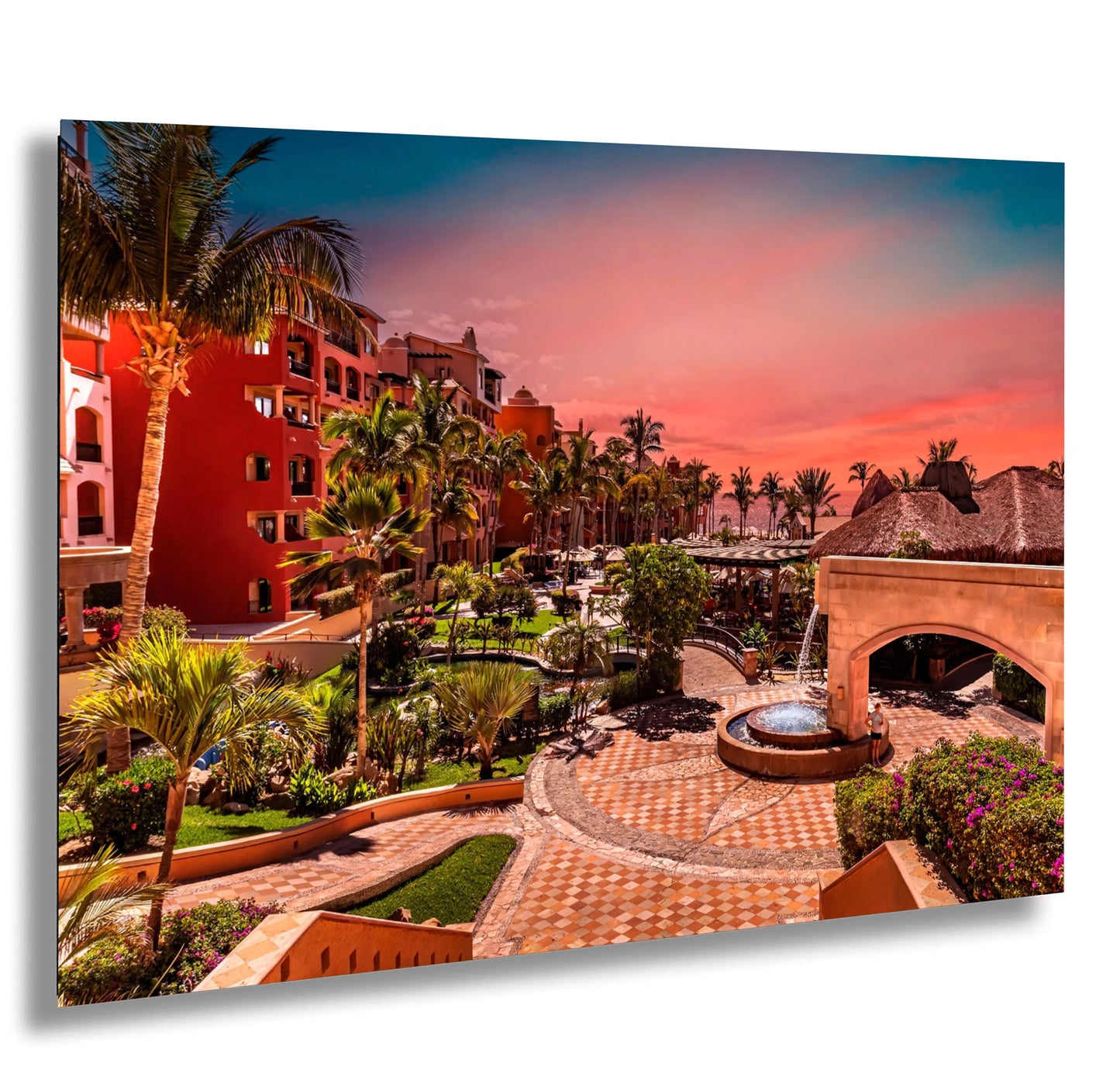 a picture of a resort with a fountain and palm trees