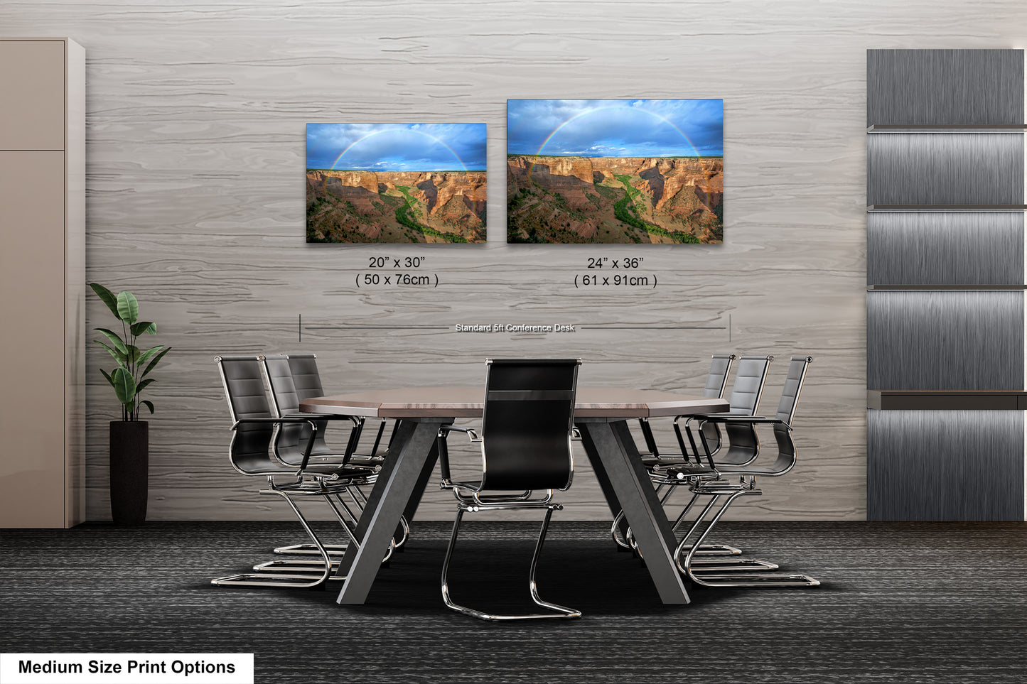 a dining room table with four chairs and two pictures on the wall