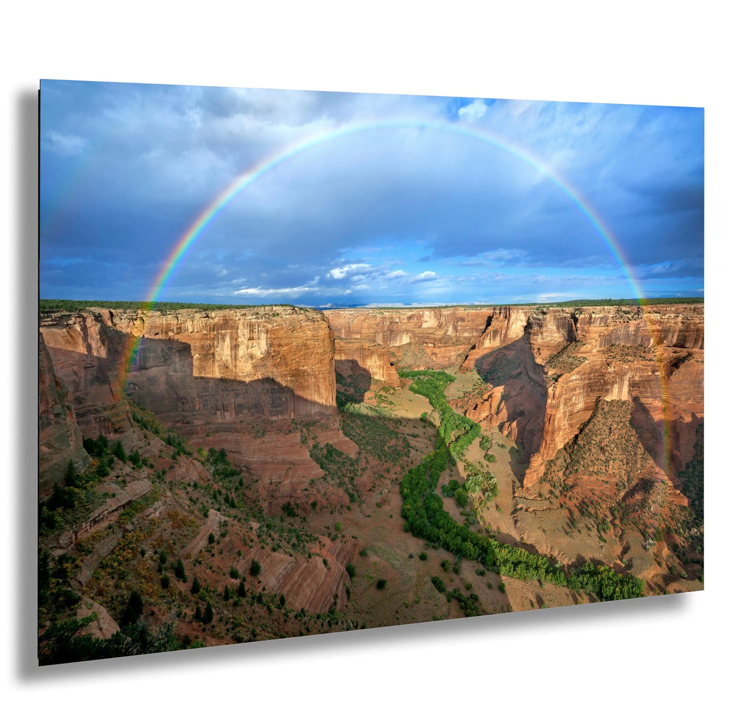 a rainbow over a canyon in the desert